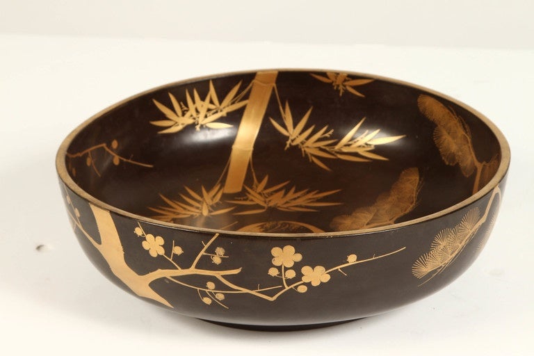 A Japanese lacquer bowl illustrating the four seasons in a gold. Meiji (1868-1912).