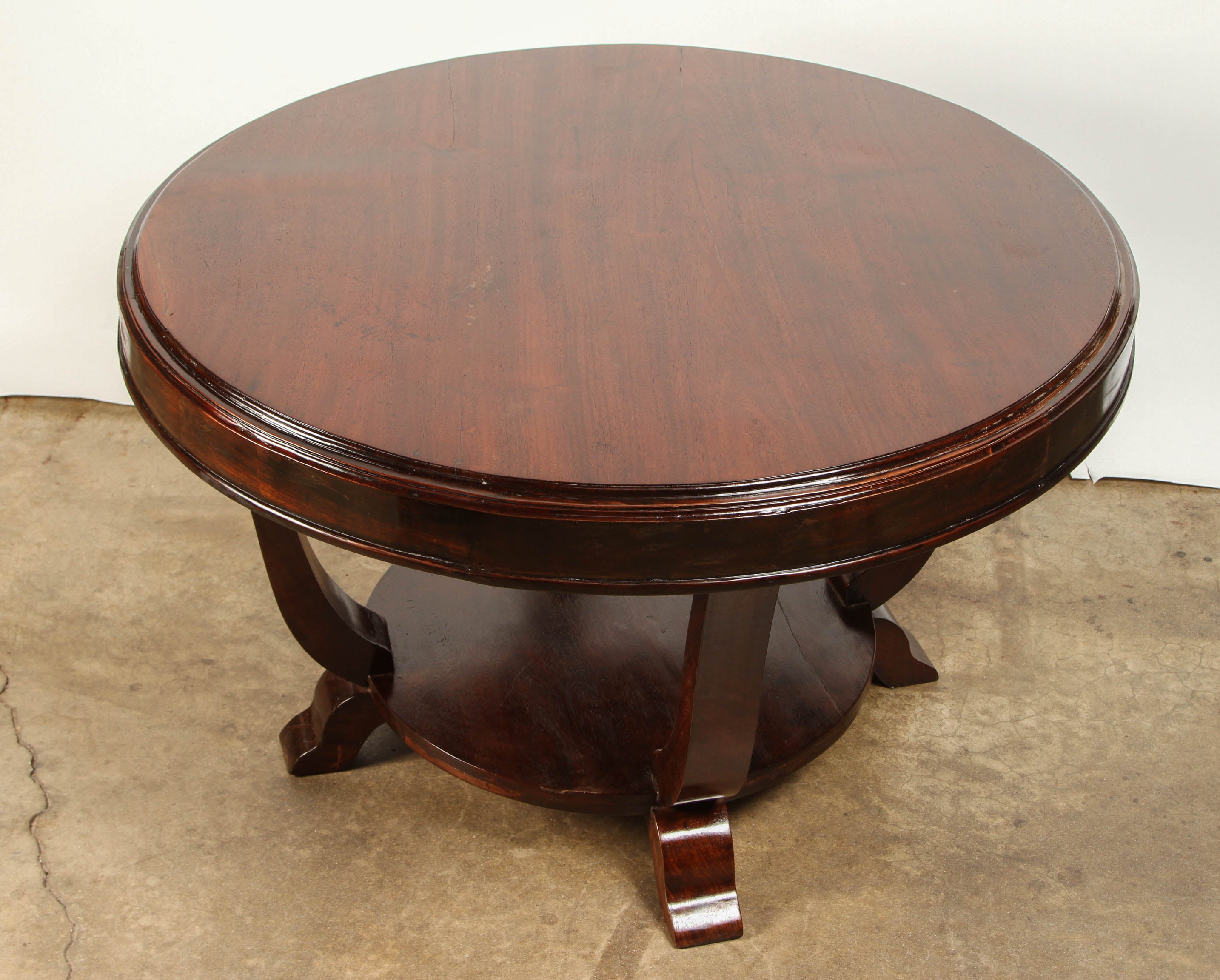 Handsome and large round table of solid rosewood. Made for the local French expatriates in the Art Deco style.