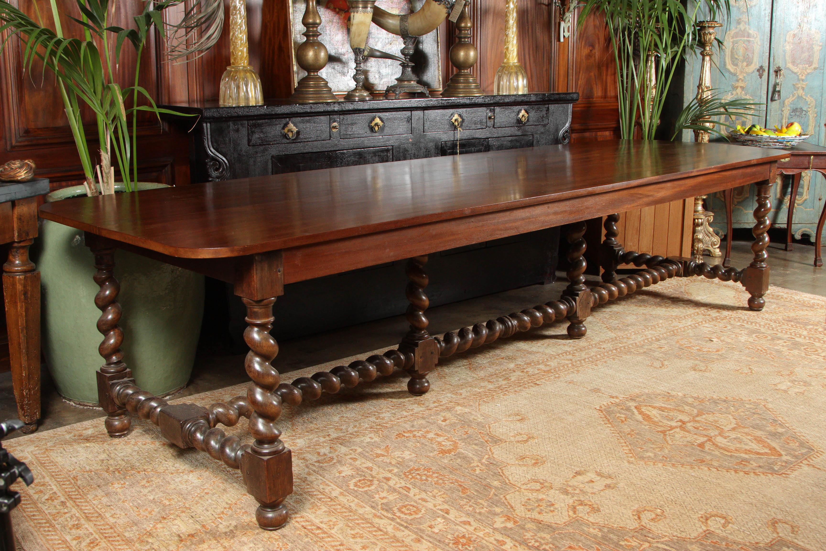 A 19th Century long French dining table, with a two plank mahogany top and turned walnut legs