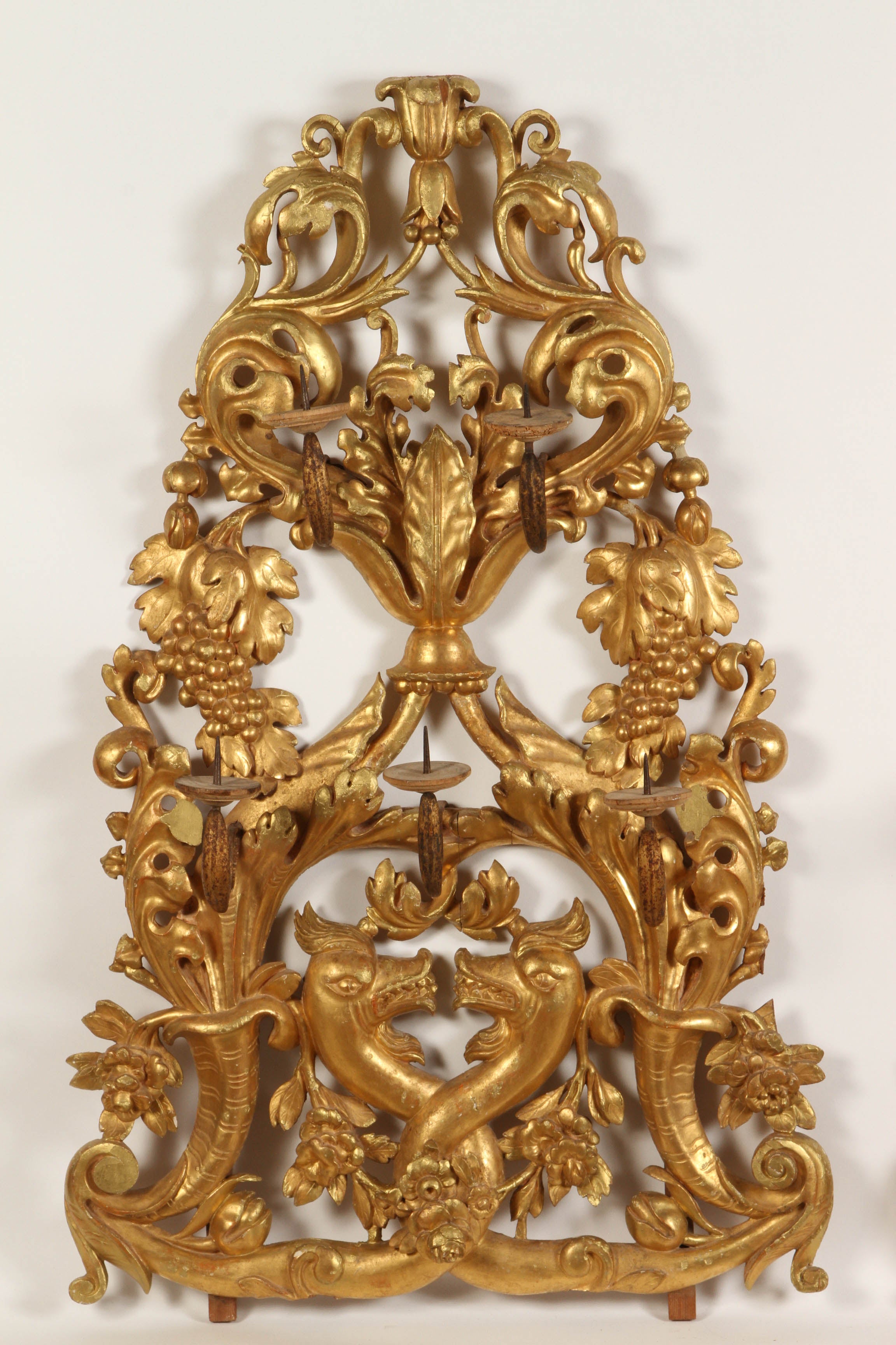 A pair of Venetian gilt wall sconces, with 5 lights for candles, grapes and acanthus leaves, with mythological sea creatures. 