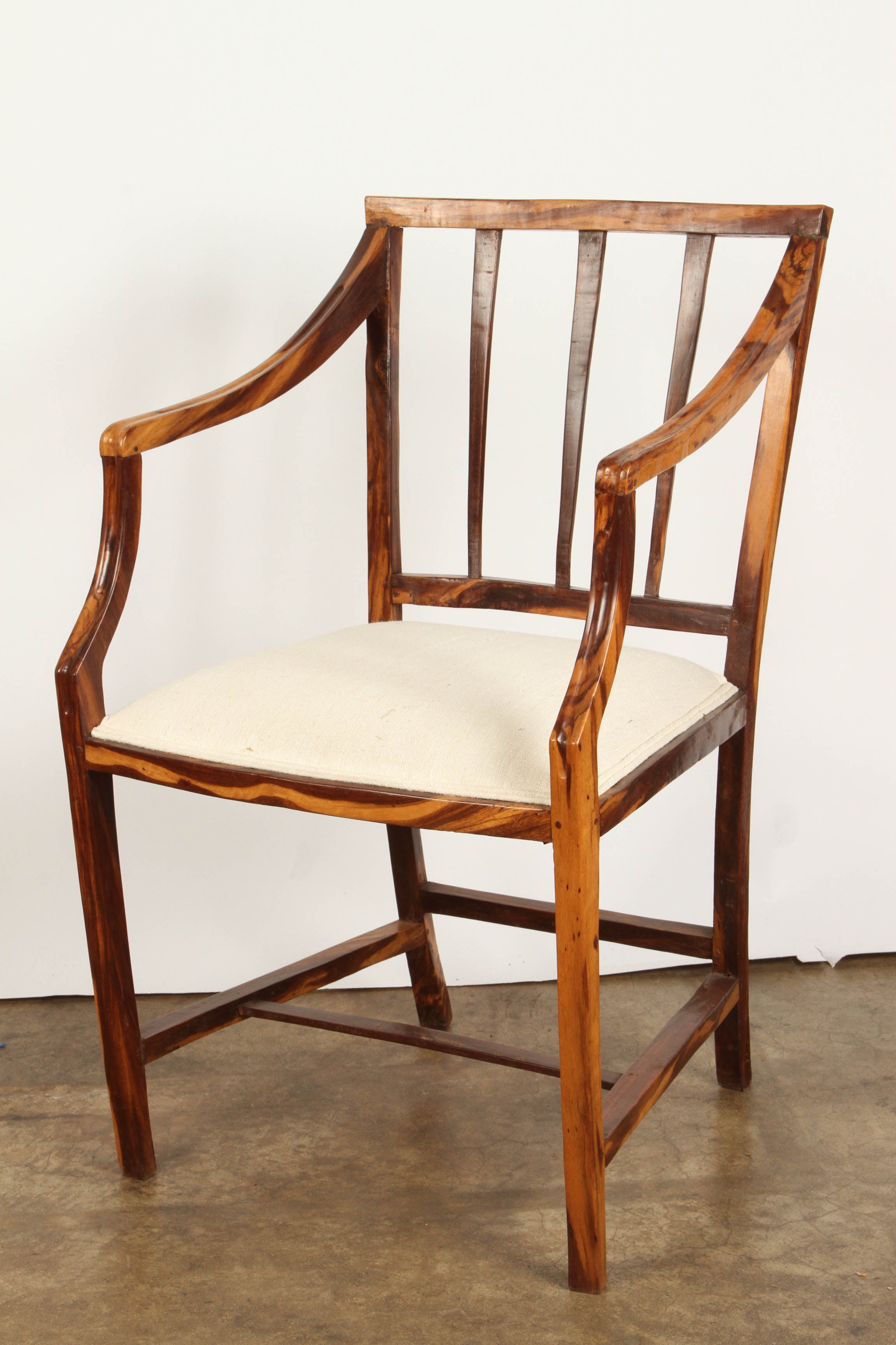 A pair of rare calamander colonial armchairs, from Sri Lanka (Ceylon). They are well figured, with new upholstery on the seats. These colonial chairs are in a simple Portuguese Colonial design.