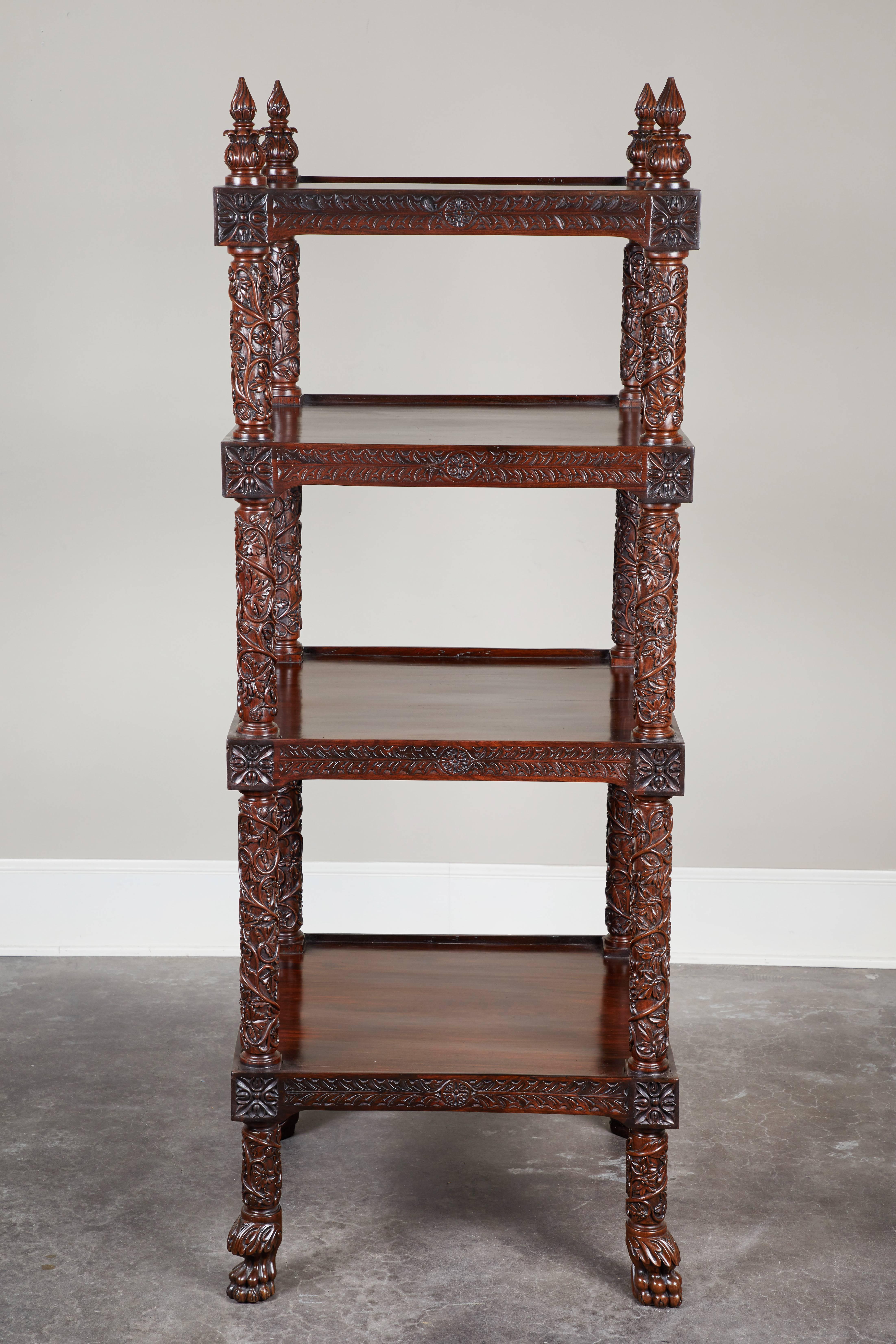 A 19th century four-tiered rosewood carved étagère. Intricately carved legs feature a flora and fauna motif.