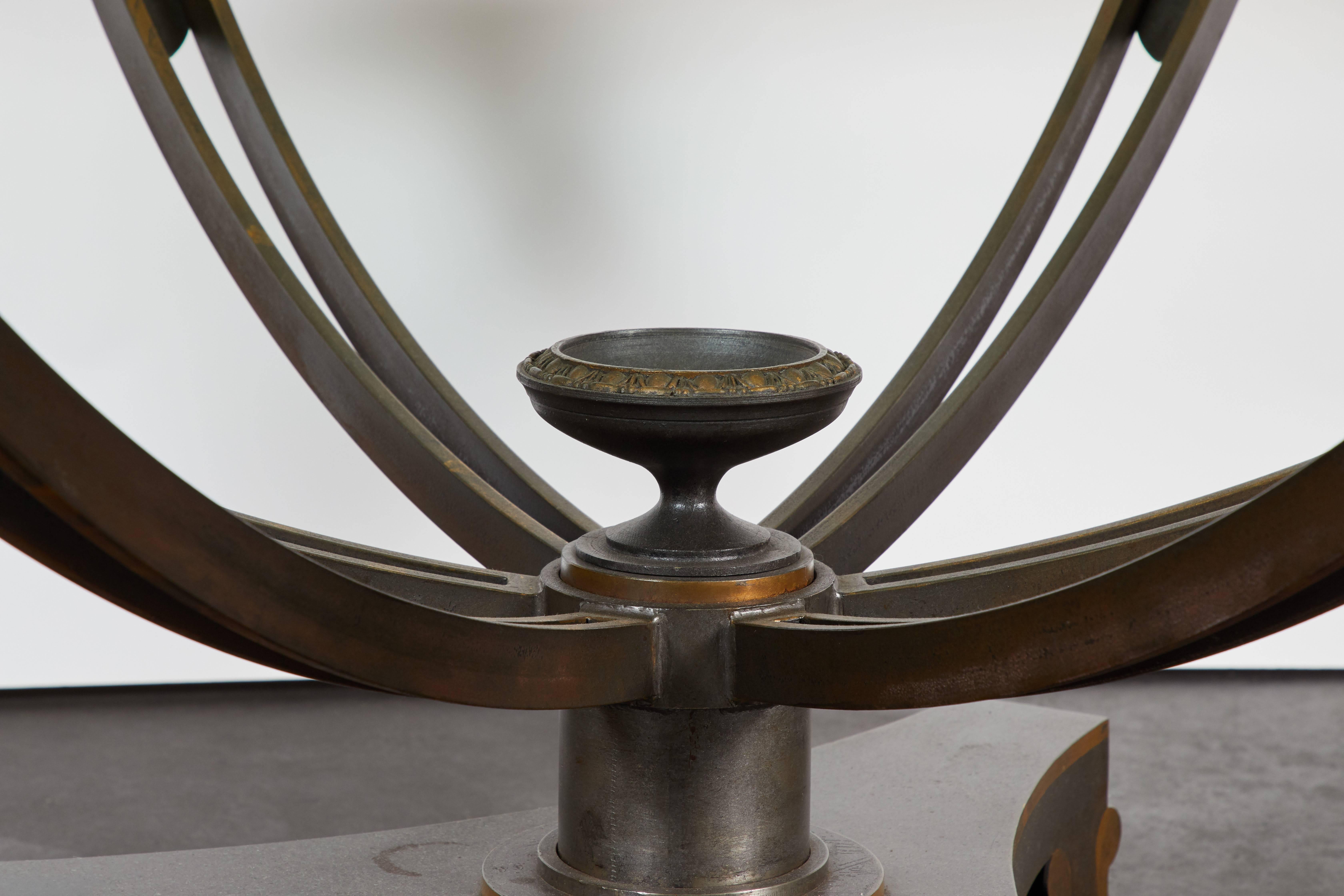 A handsome 1950s neoclassical style bronze center table featuring a glass top. The tables features also include a central finial with intricate egg and dart detailing.