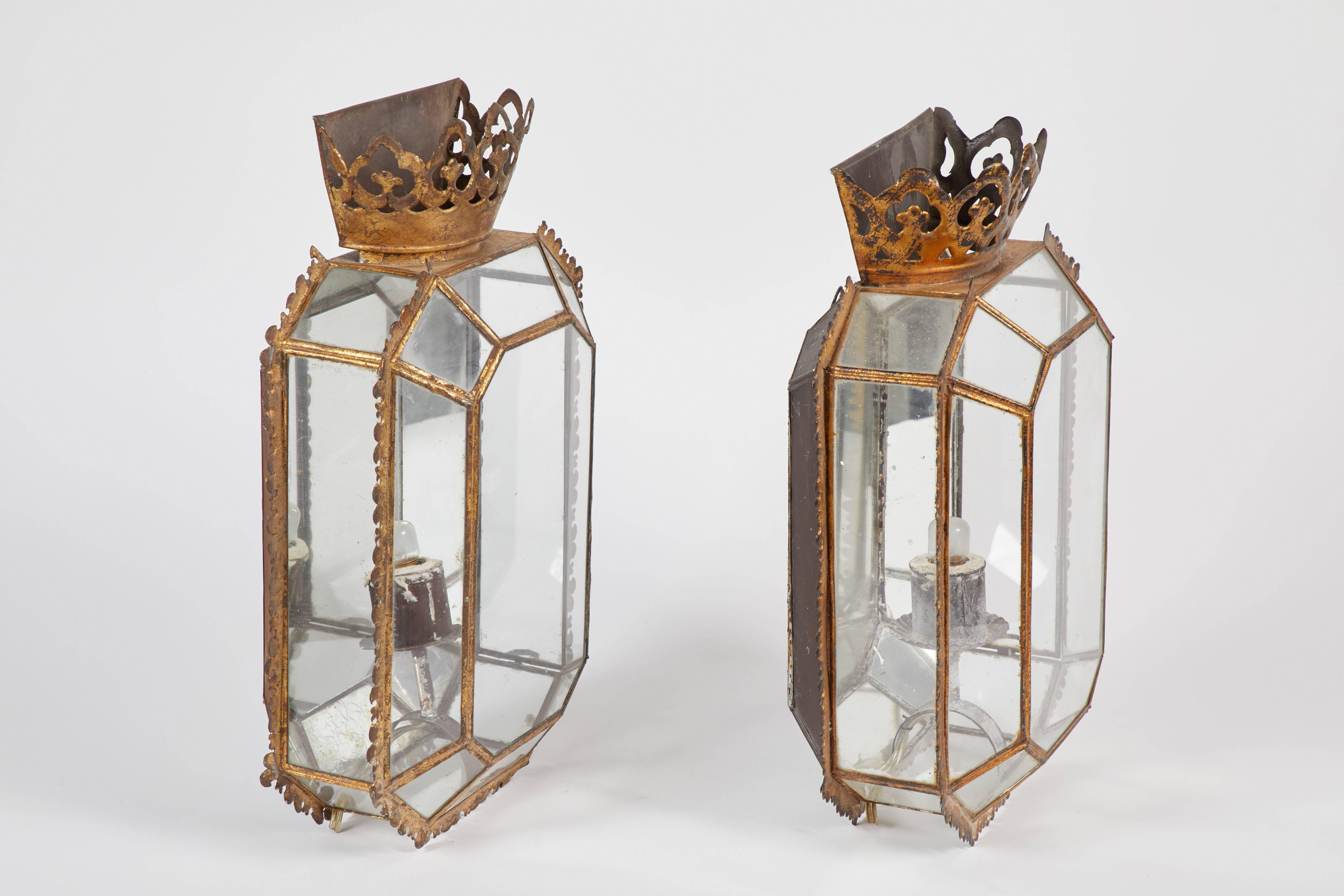 A pair of English Regency glass and tole sconces, circa 1820’s.  These sconces have at one time been electrified, but that will need to be redone.