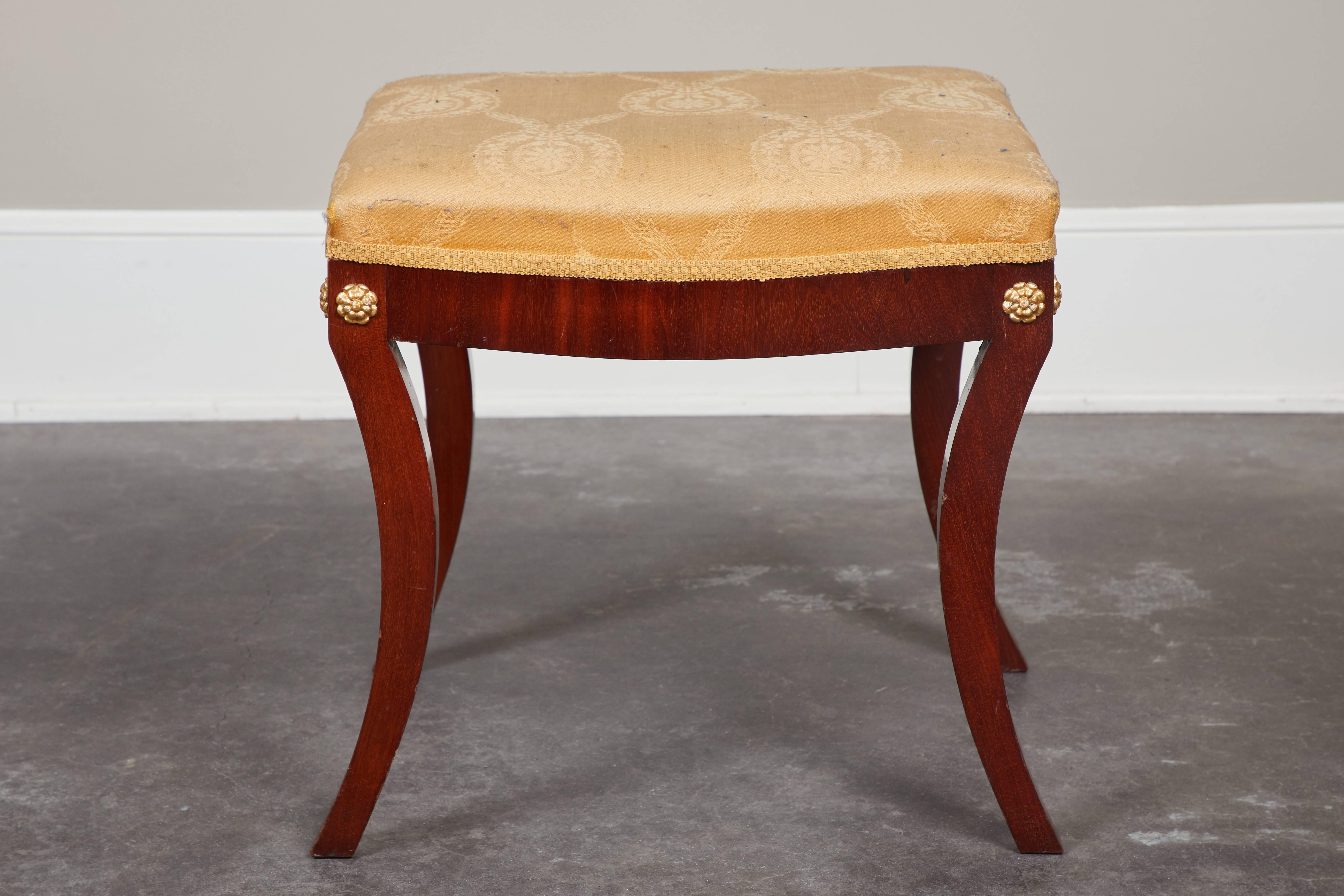 Pair of early 19th century Swedish empire mahogany stools with bowed legs and brass fittings at corners.