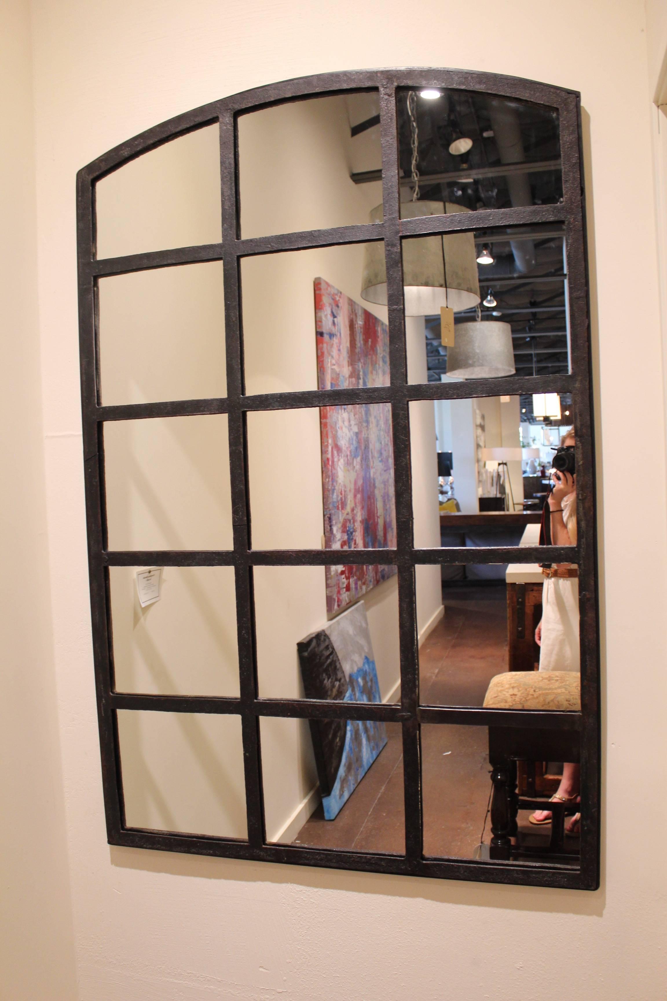 Industrial iron arch window frame mirror.
15 window frame with mirrored glass.
Cast iron patinated natural black patina.
Can be placed indoor or outdoor mirror.

Origin: English warehouse window frame, 1930.