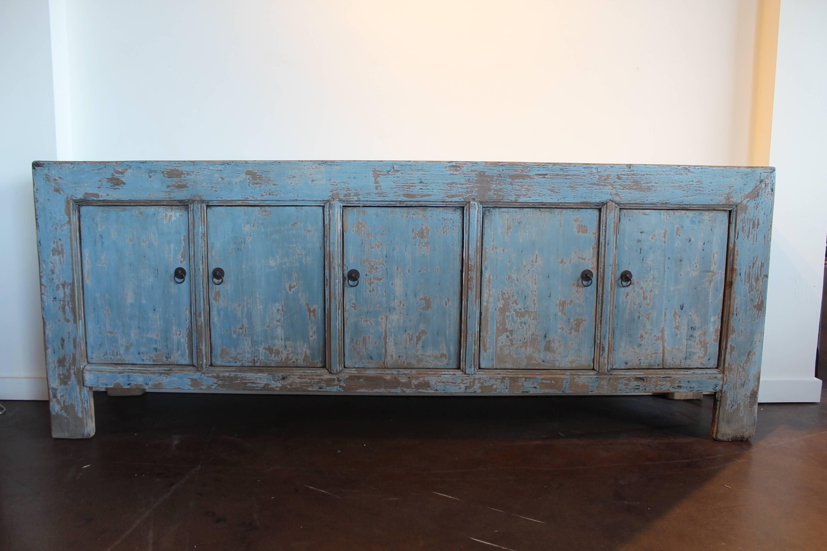 Natural distressed with Robin's egg blue coloration sideboard piece.
Five elm drawers with vintage bronze hardware.
Natural elm wood is exposed above the sideboard. 
 
Open spaced shelving with one long shelf inside. Easy to open and close