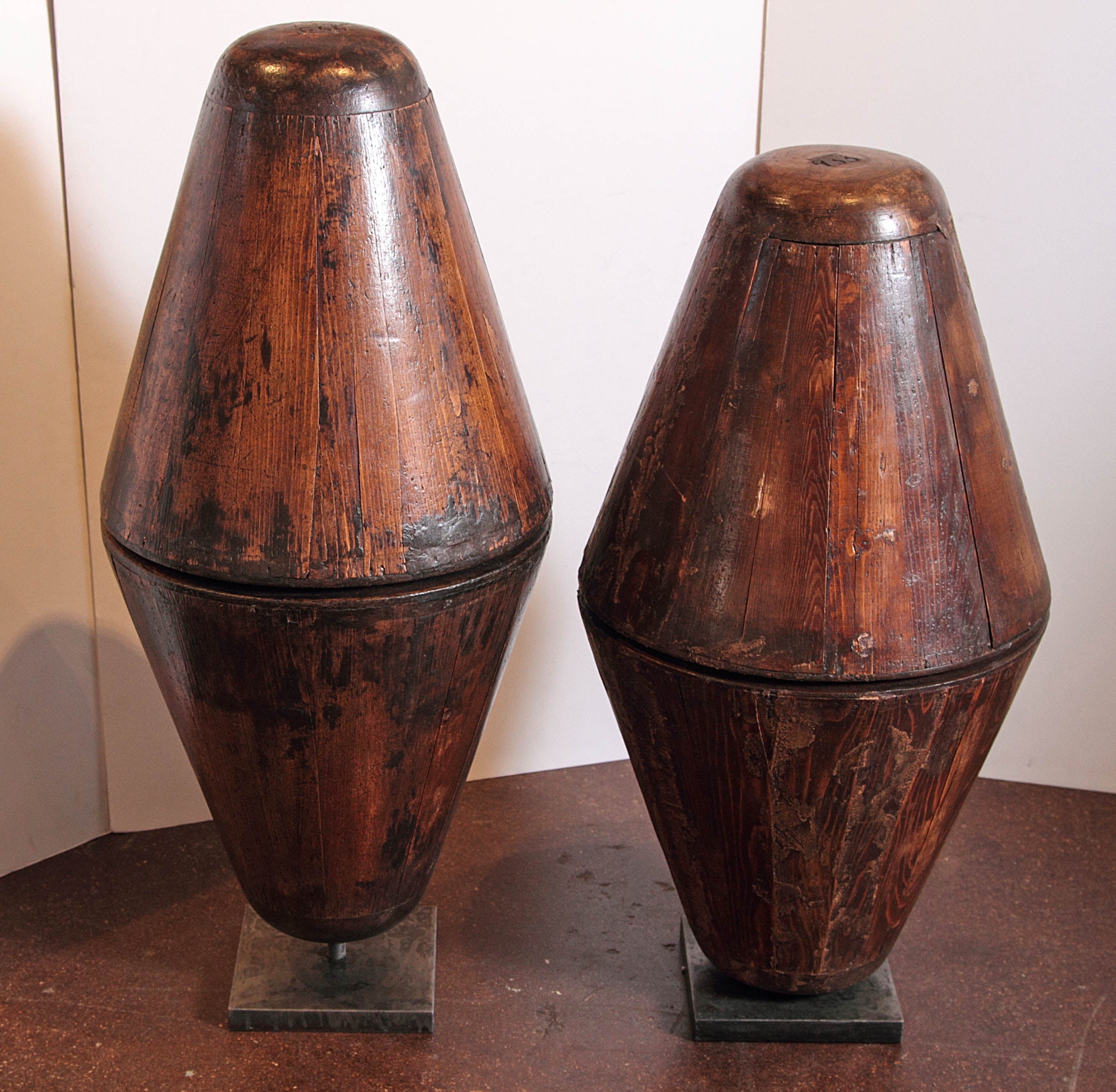 Antique French Hat Molds 
On cast iron stands 
The pine wood is in great condition, and a stunning appeal 
Belonged to a shop in the 1920's in Paris 
These can be creative in the aesthetic of sculpture pieces, large table decor, to simply