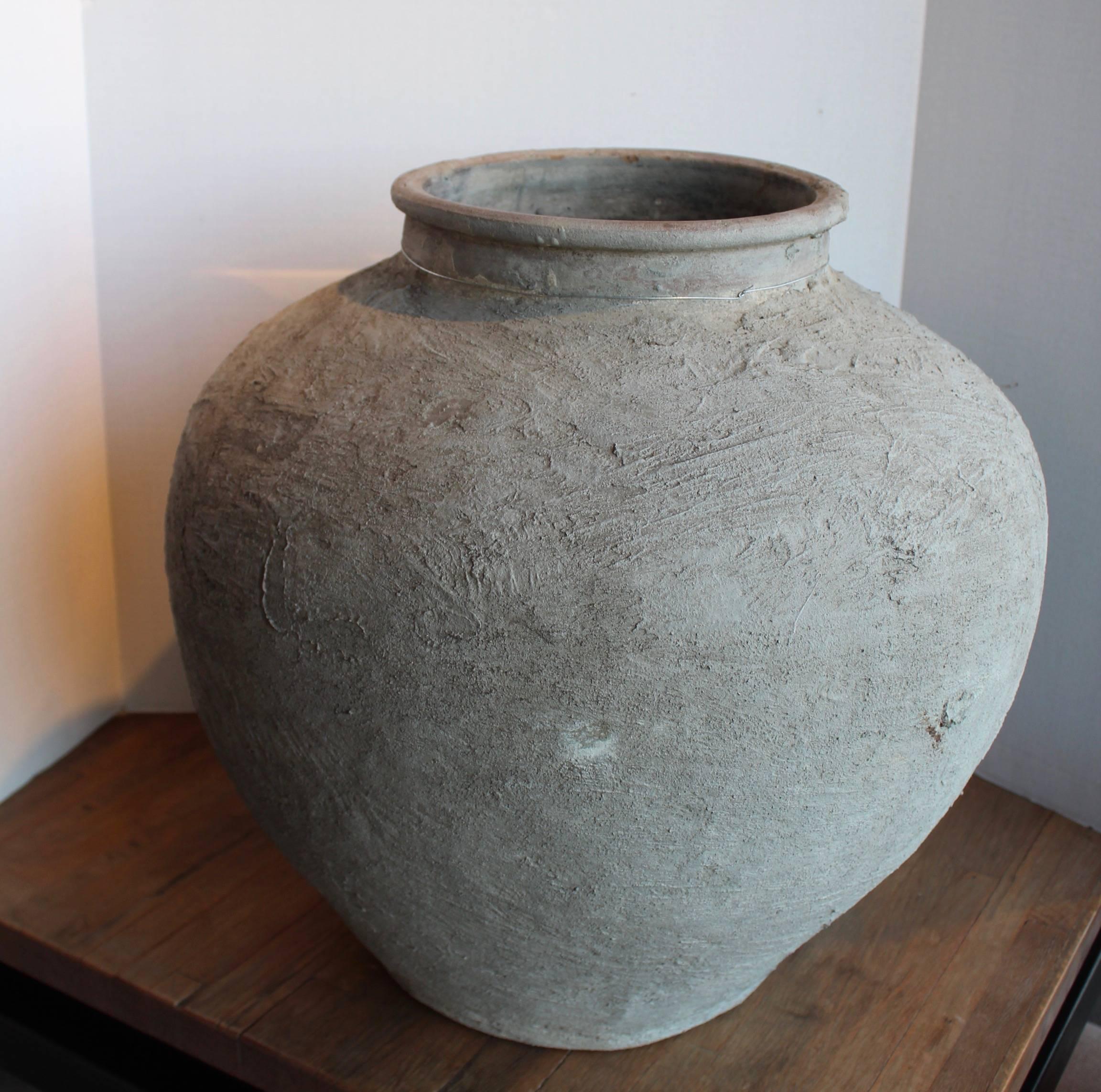 Primitive antique terra cotta jar. 
Antique, 1900s, France. 
Natural rough cement-like edges around jar.
Indoor or outdoor.