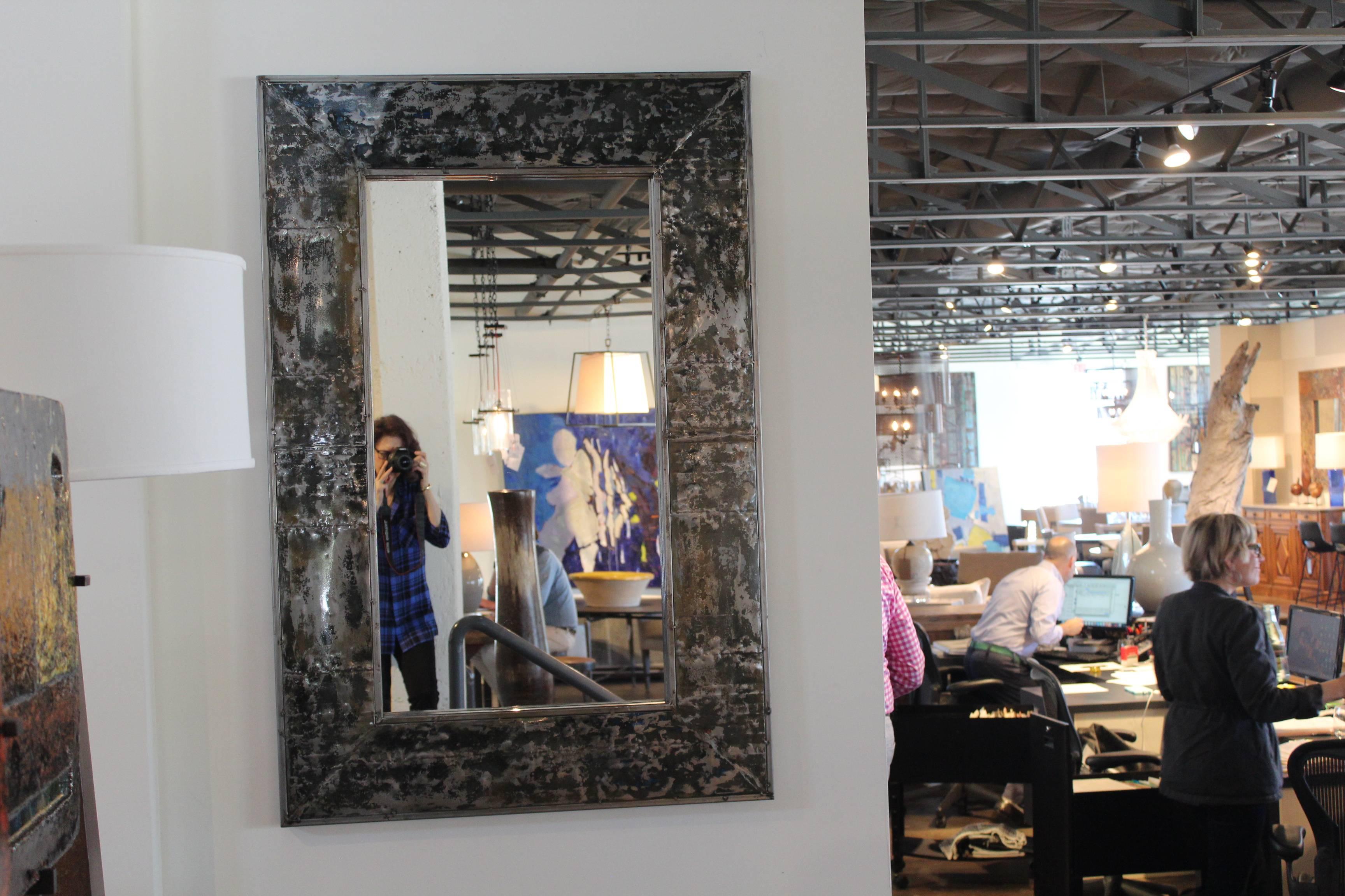 Mirror frame crafted from reclaimed painted zinc.