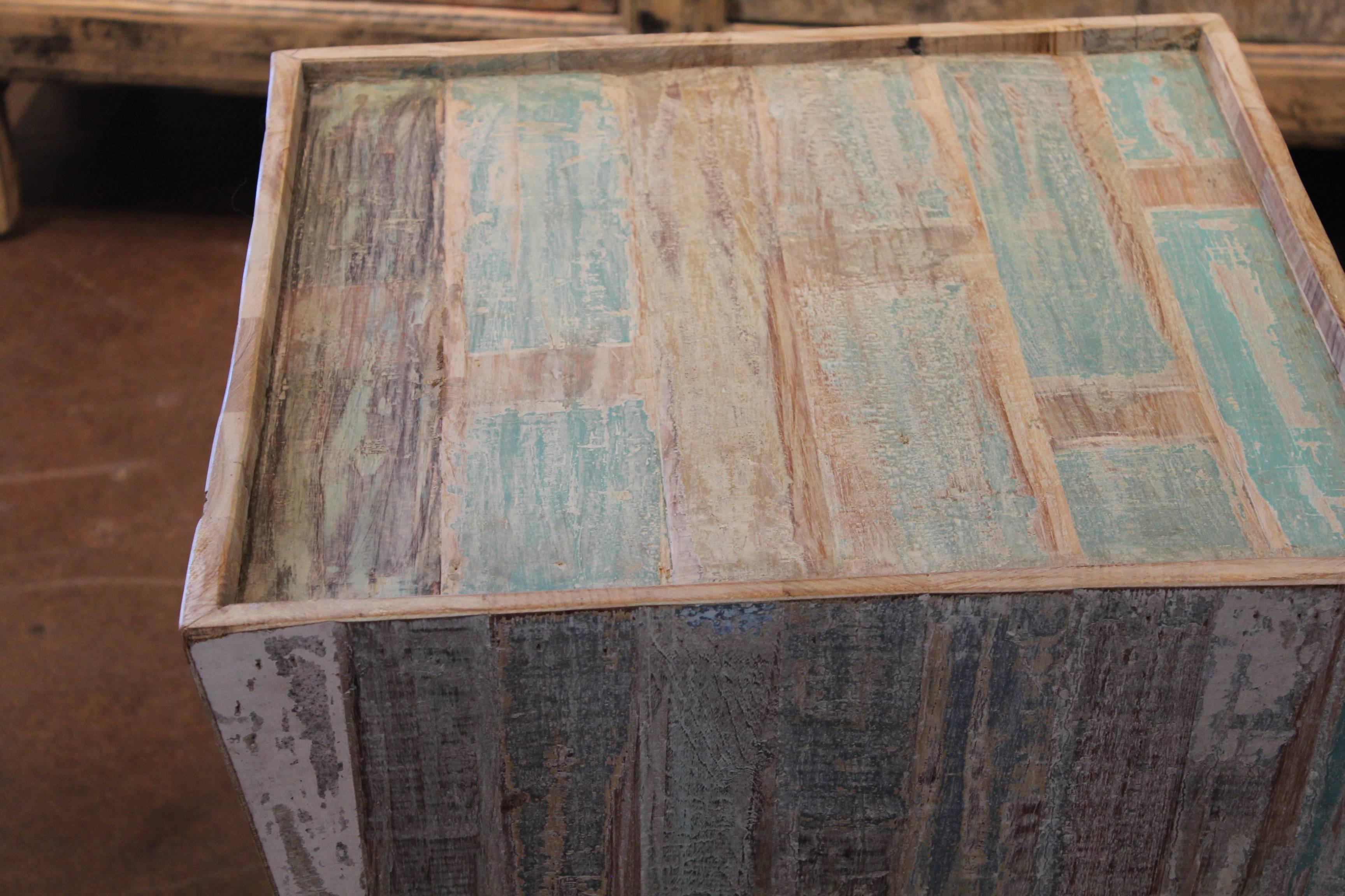 Multi-toned end table made from reclaimed elements.