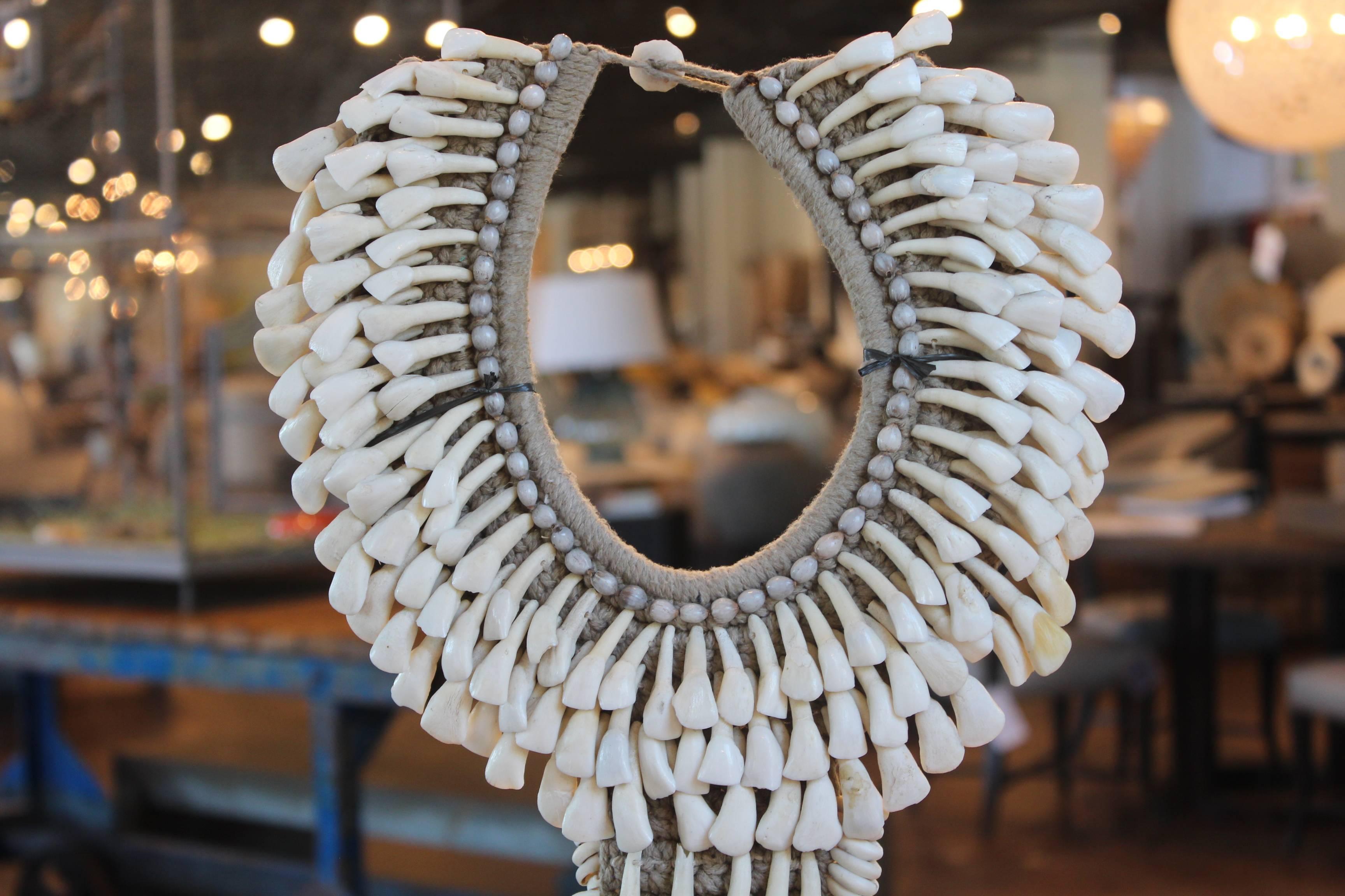Tribal necklace on mount, made of goat teeth, and woven into a hemp collar base.