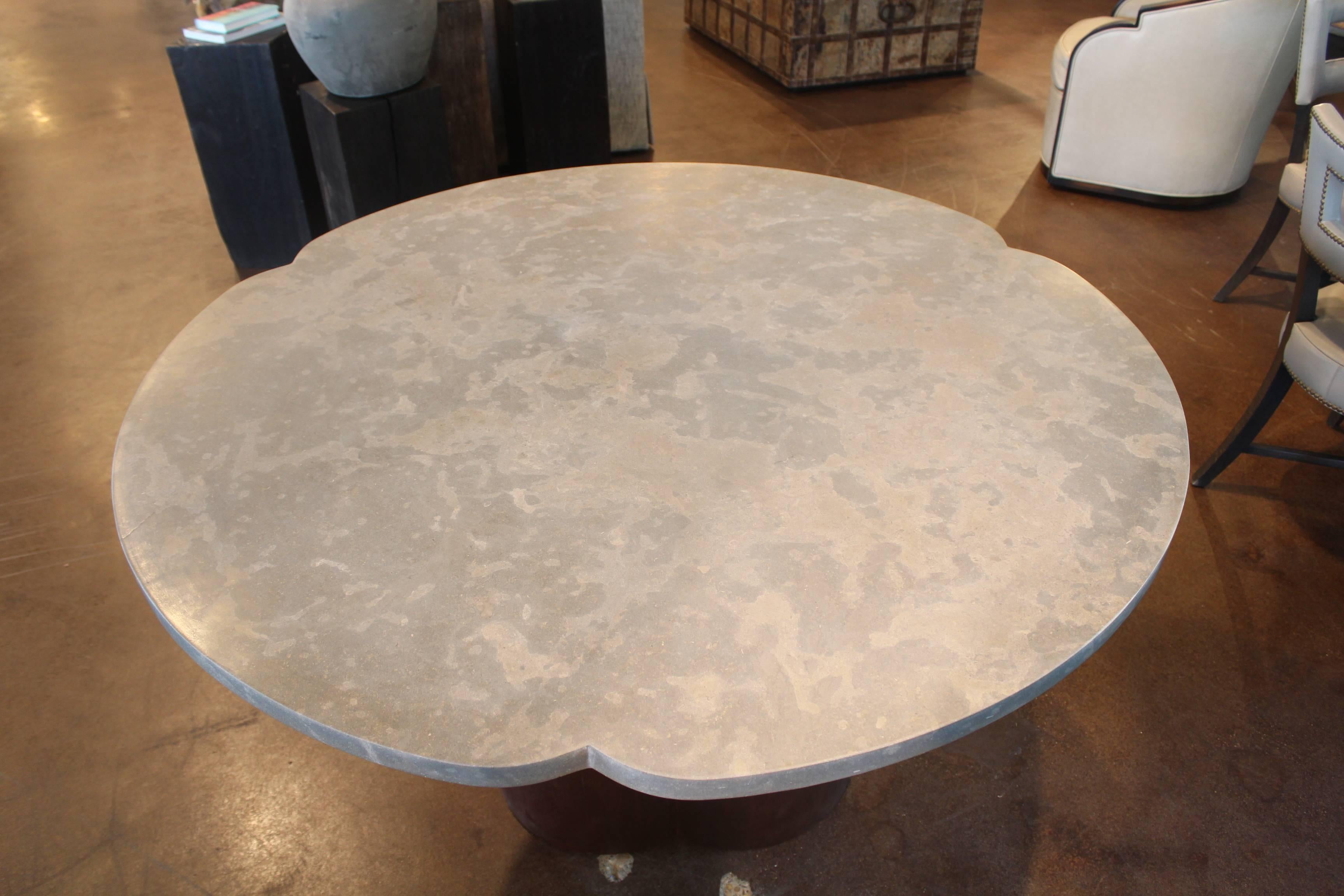 Clover shaped Italian dining table base, with honed lagos azul limestone top.