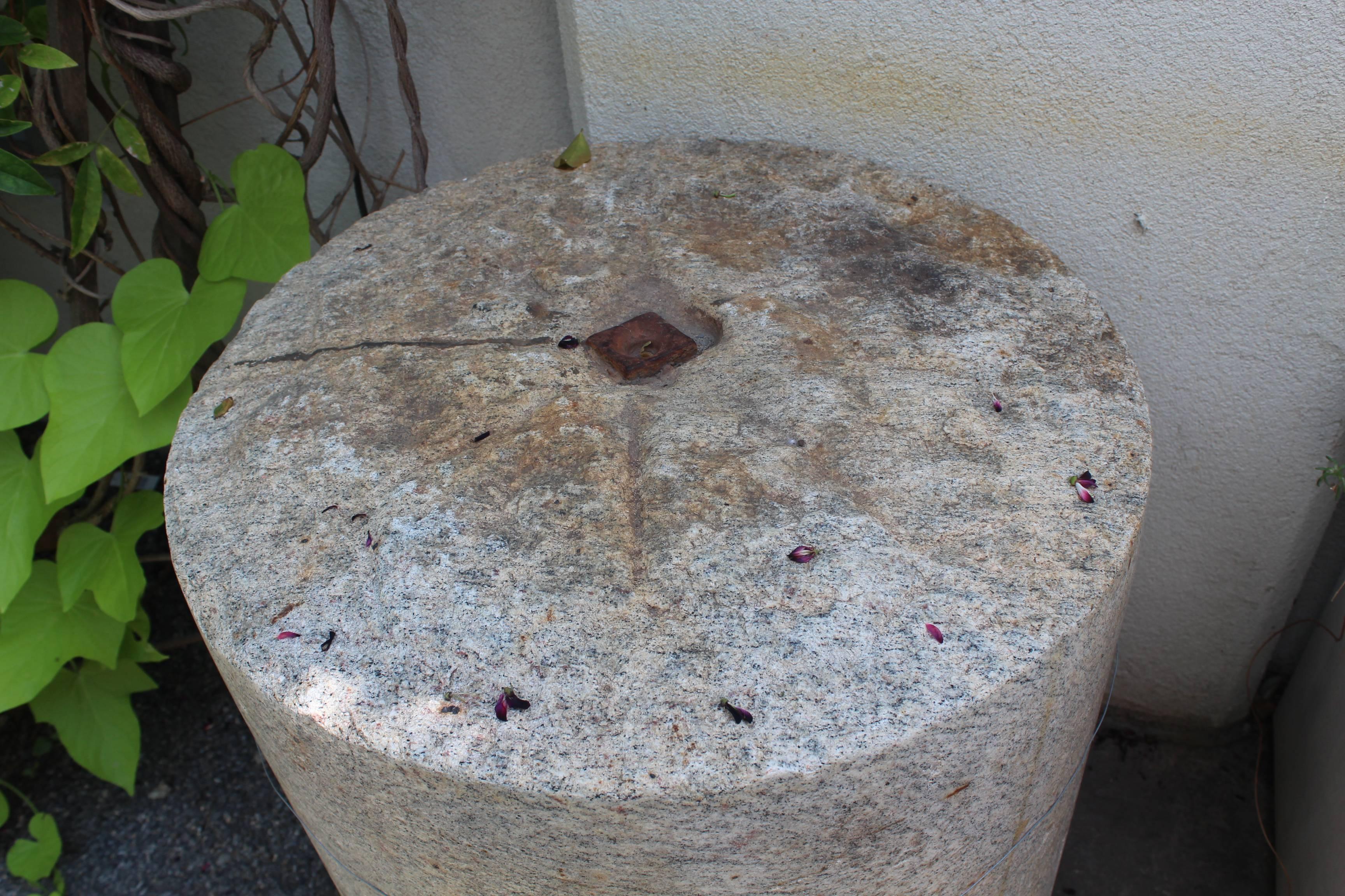 Antique French granite turf roller as table base.