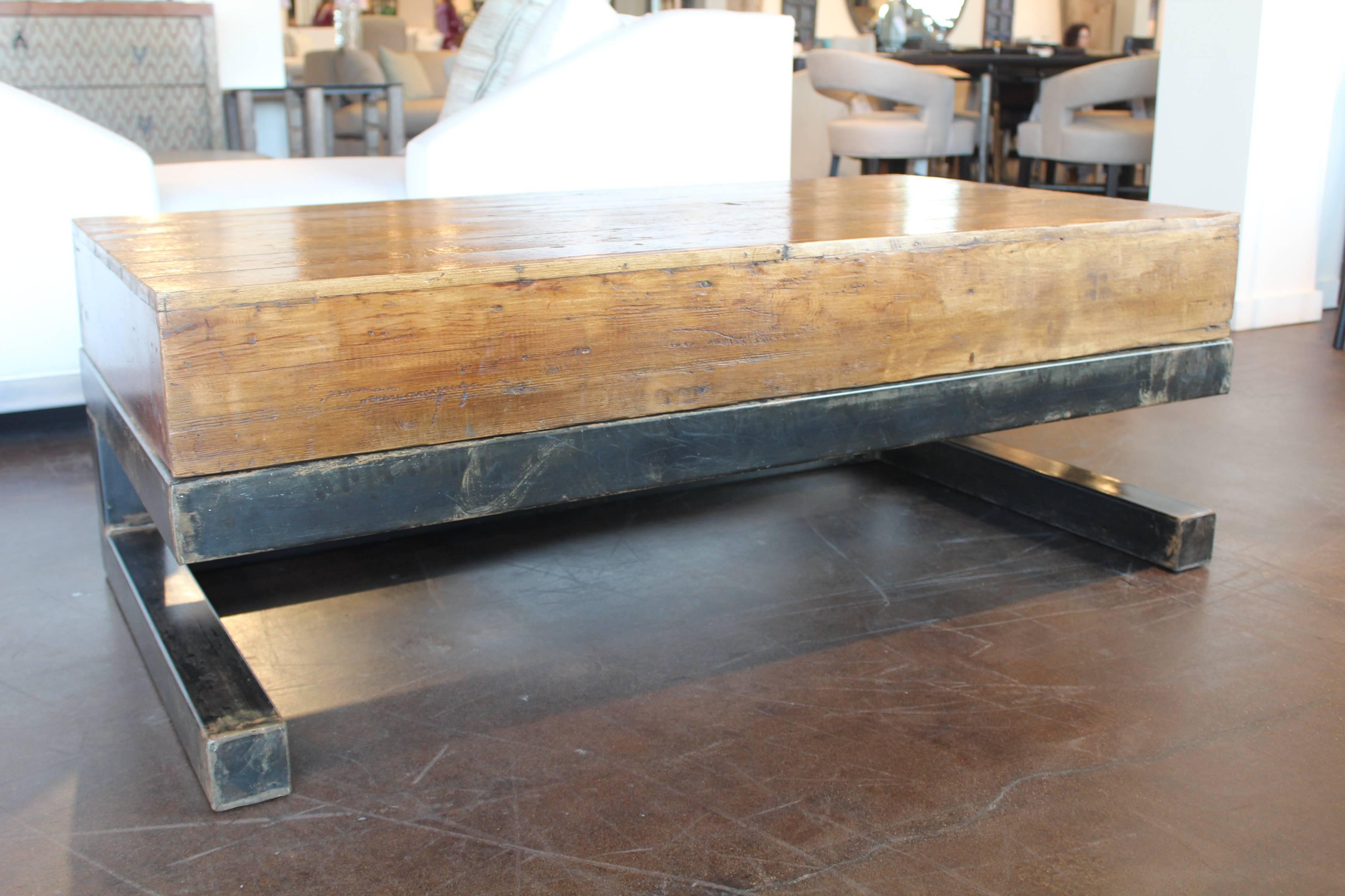 Vintage french pine factory work platform with steel base as coffee table.