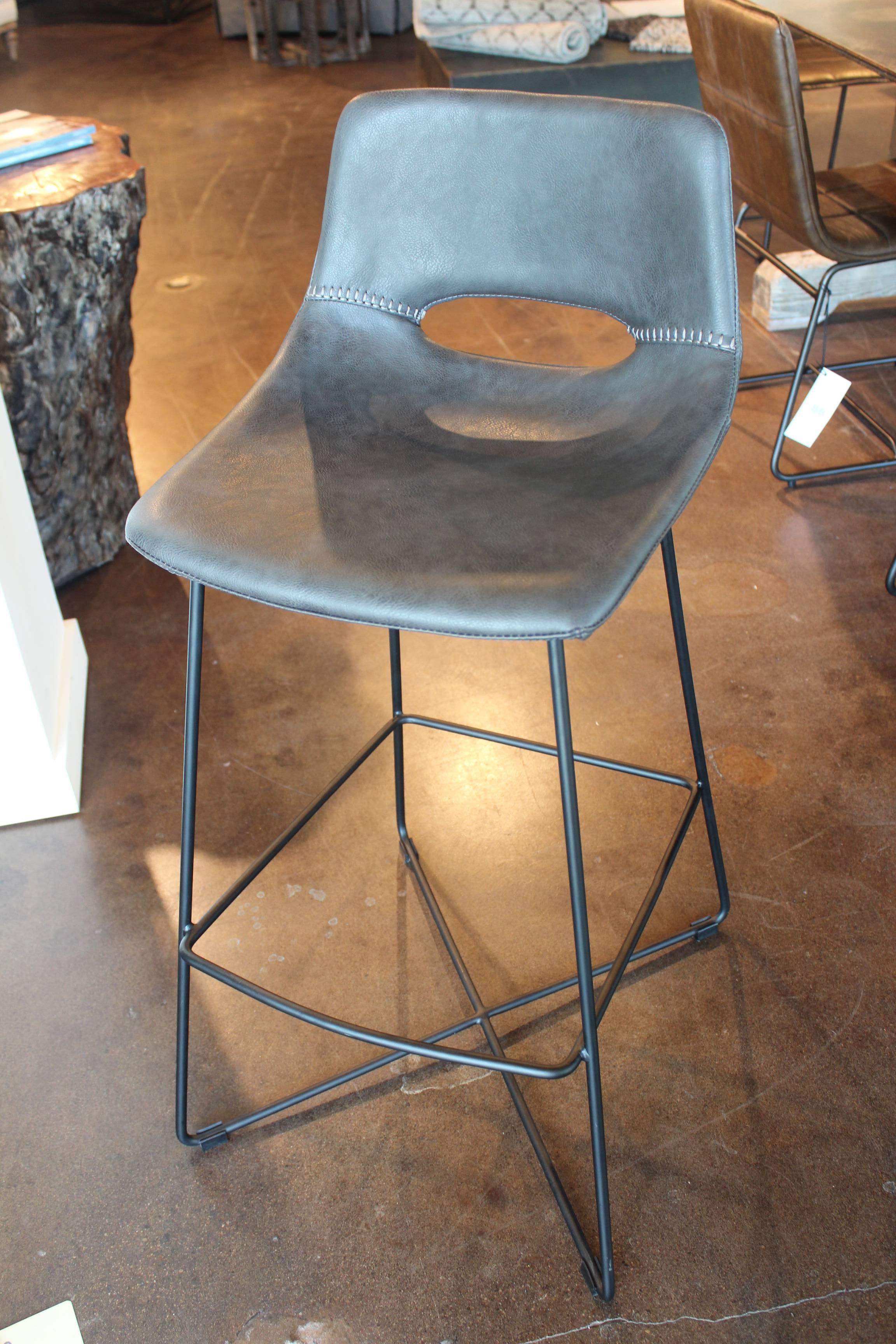 Contemporary bar stool in bonded leather.