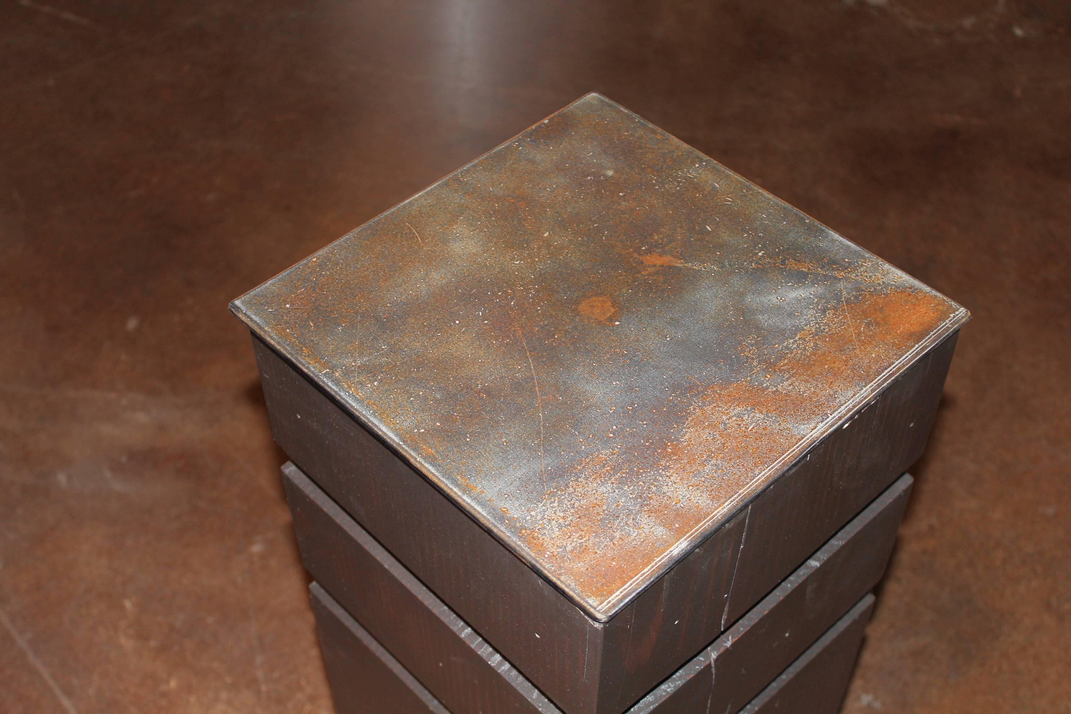 Reclaimed beam base with steel top as end table.
