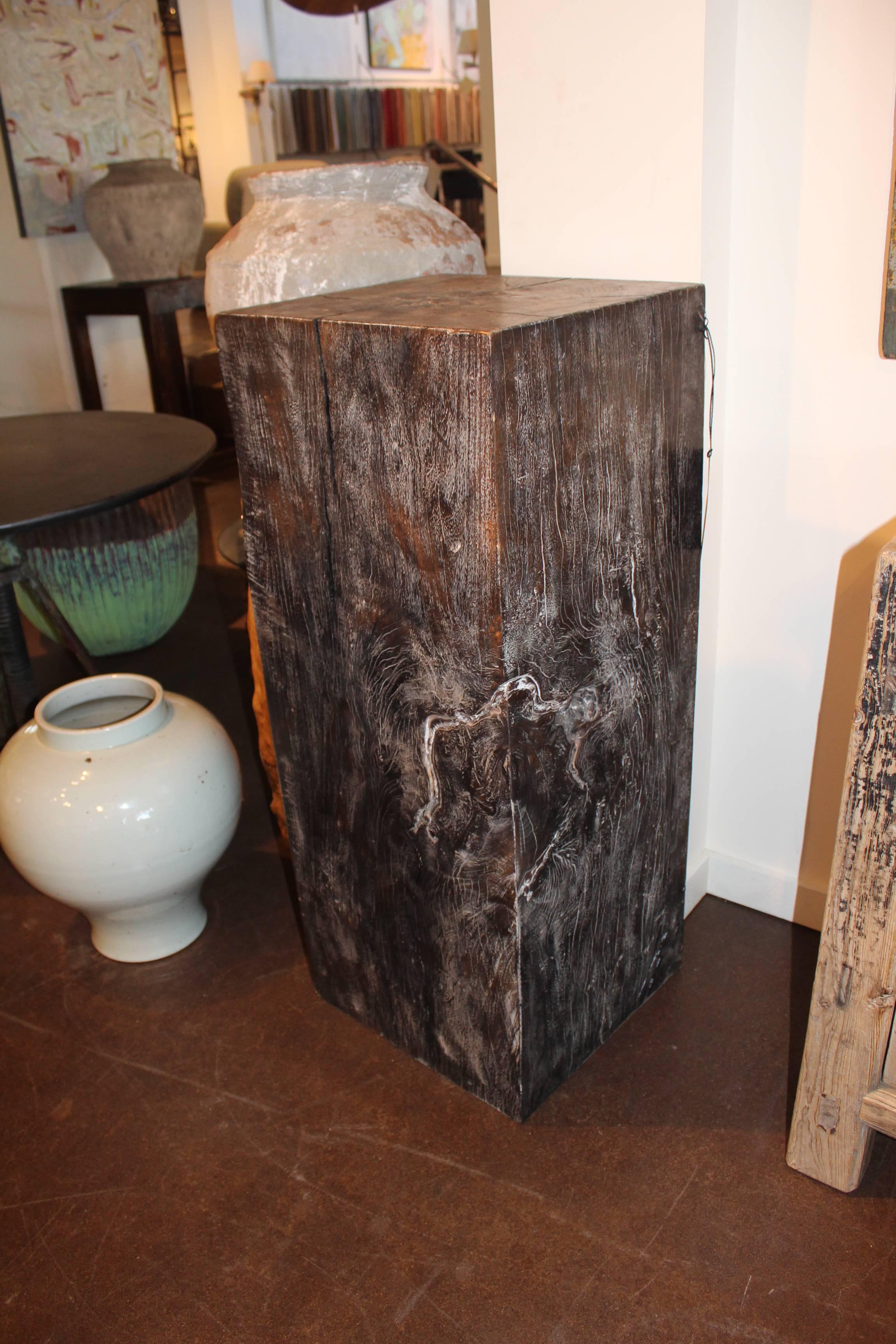 Contemporary form ebonized rainbow wood pedestal.