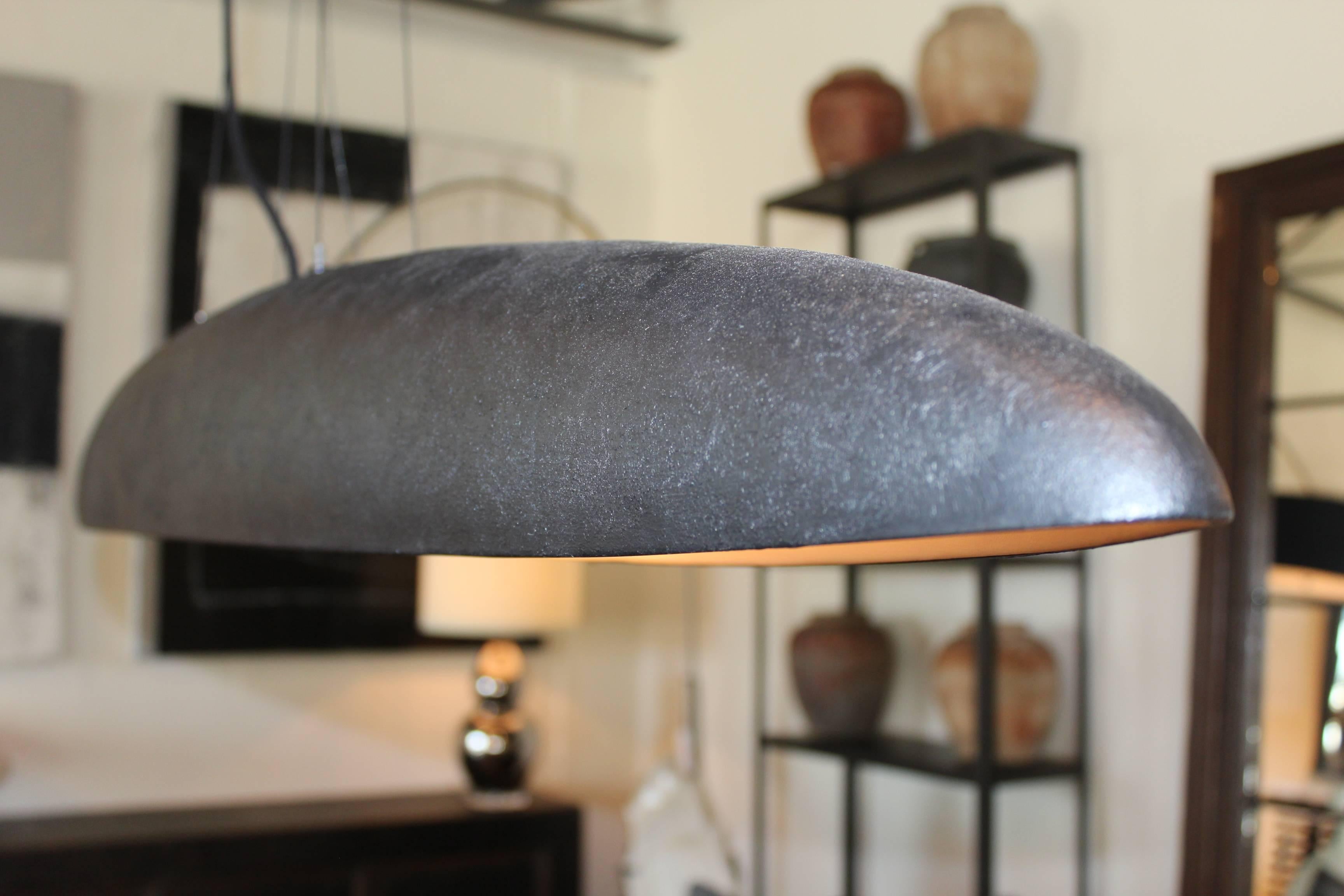 Elongated oval chandelier designed by Brendan Bass. Made in Italy
Glazed ceramic with a matte charcoal textured finish. 60 watt max. Each socket (two).


Brendan Bass Custom -  Item can be reproduced