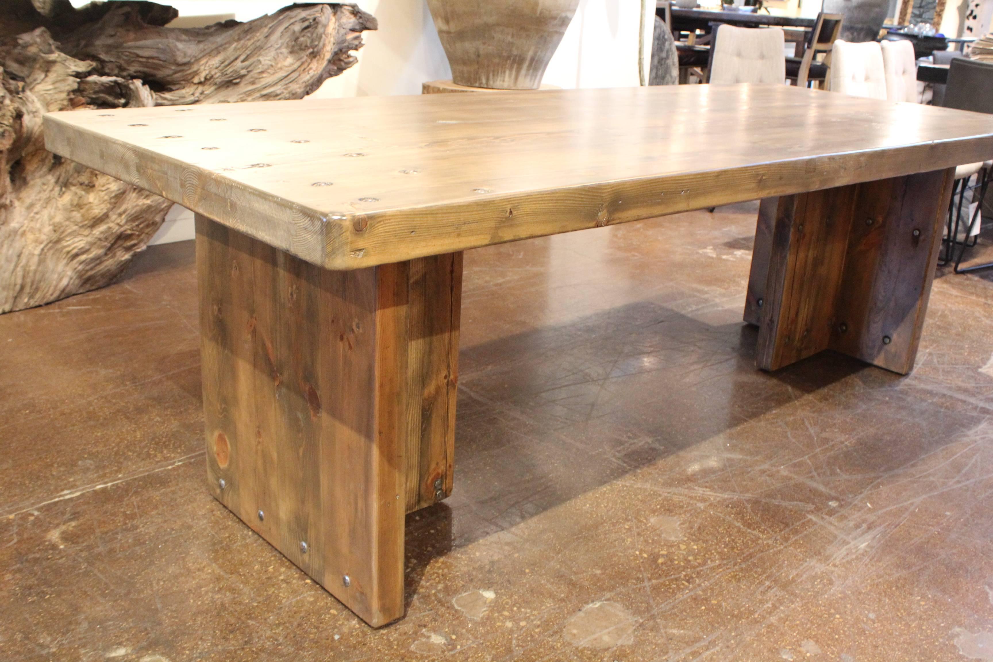 Modern dining table made from vintage French pine planking.