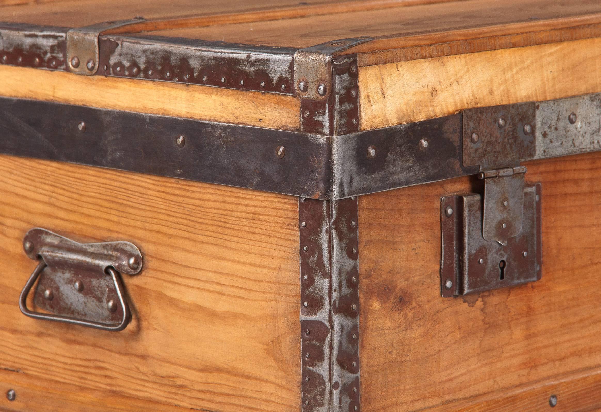 A handsome French traveling trunk, circa 1920s, made of pinewood with silver metal trim, handles and locks. The original key is available. Clean lines, great storage piece that will work perfectly as a coffee or side table.