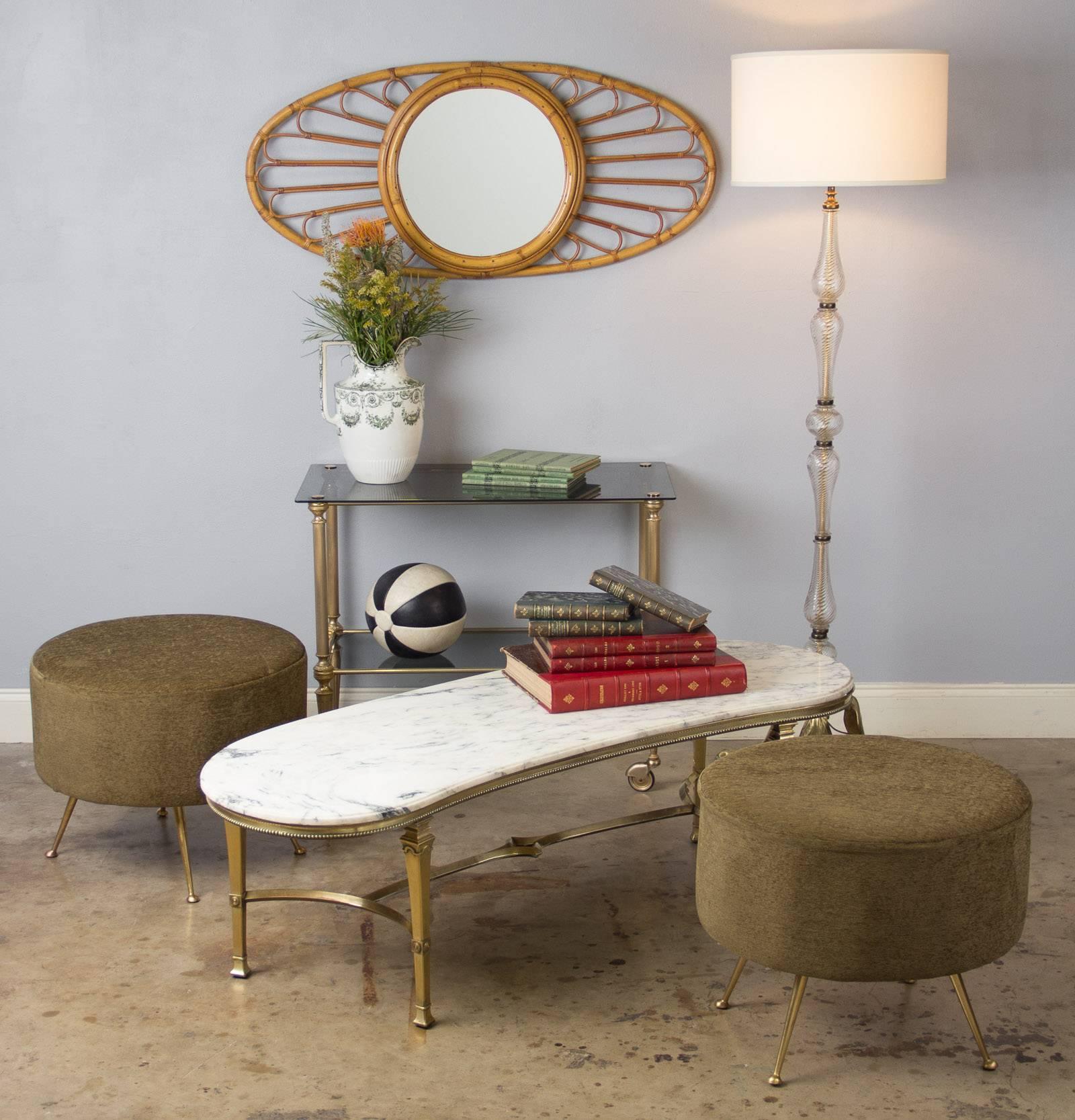 A kidney shaped cocktail table from Italy, circa 1960s, featuring a beveled Carrara marble top on a brass base. The base has tapered legs, a curved stretcher and a beaded apron. The marble separates from base.