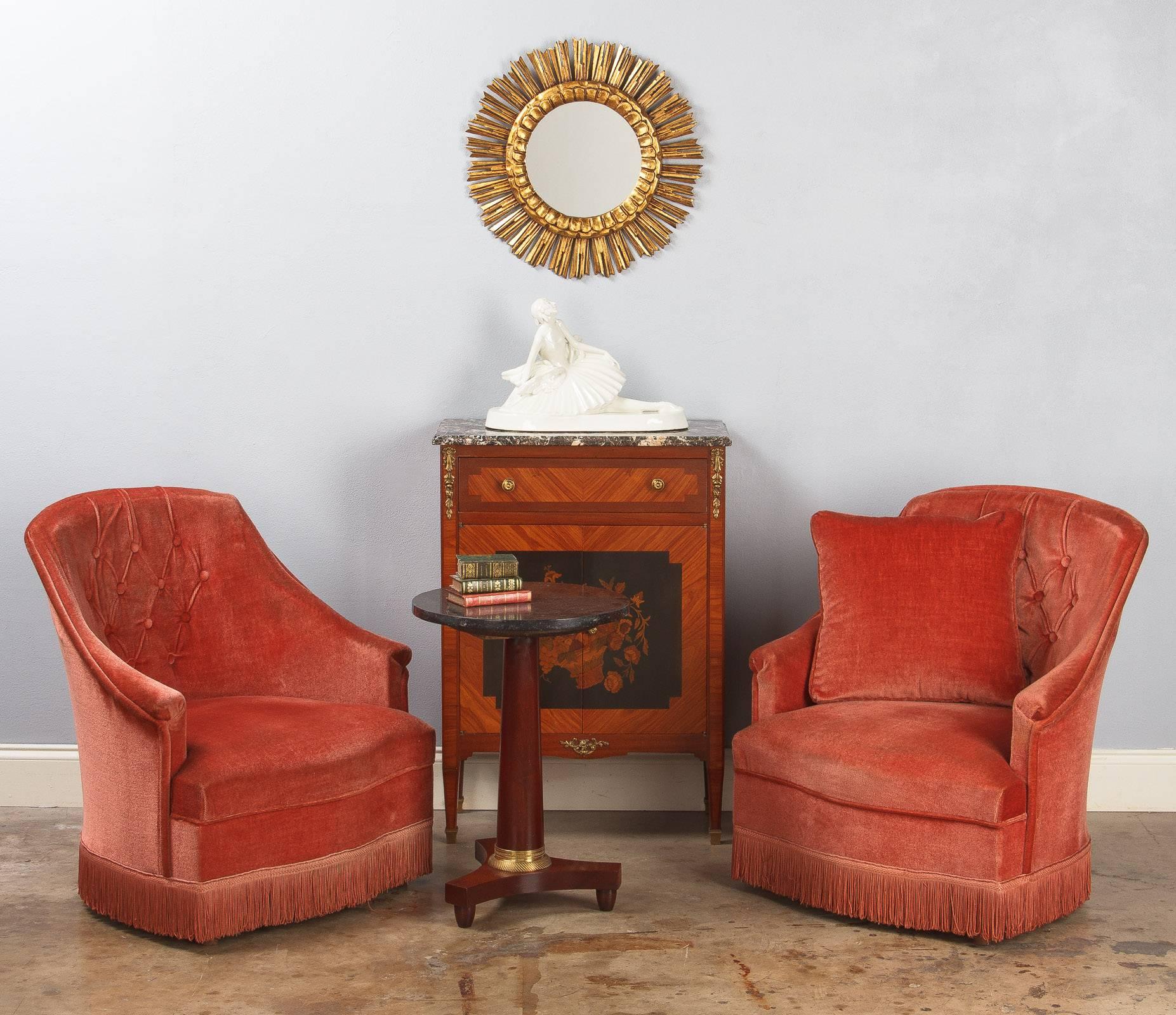 A pair of Napoleon III style Boudoir armchairs, called "Crapauds," lined in velvet fabric in rose tones with tufted rounded backs. Fringes around the apron are hiding wooden feet. Small size armchairs but quite comfortable. From floor to