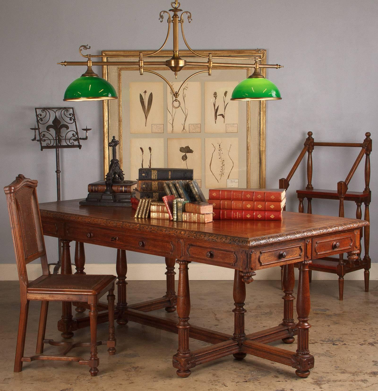 A beautiful accent chair in the Renaissance Revival style made of walnut with embossed leather on seat and back. The leather features grapevine motifs and is fixed with antique nails. The walnut frame has fluted baluster legs and an H-shaped
