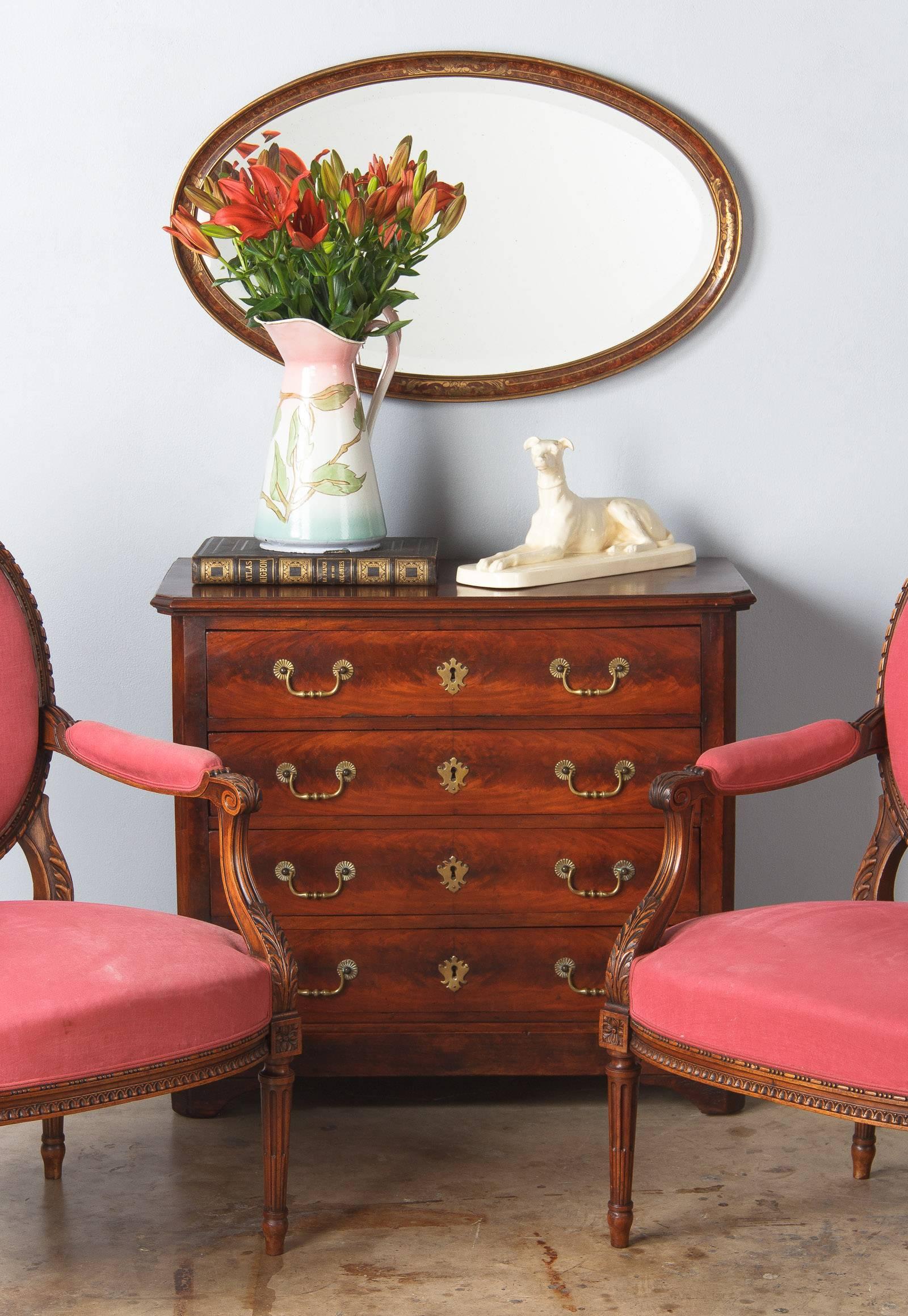 A Louis Philippe chest of drawers from the Provence region made of mahogany veneer. The commode rests on bracket feet, the four drawers have shaped brass drop handles and key escutcheons.