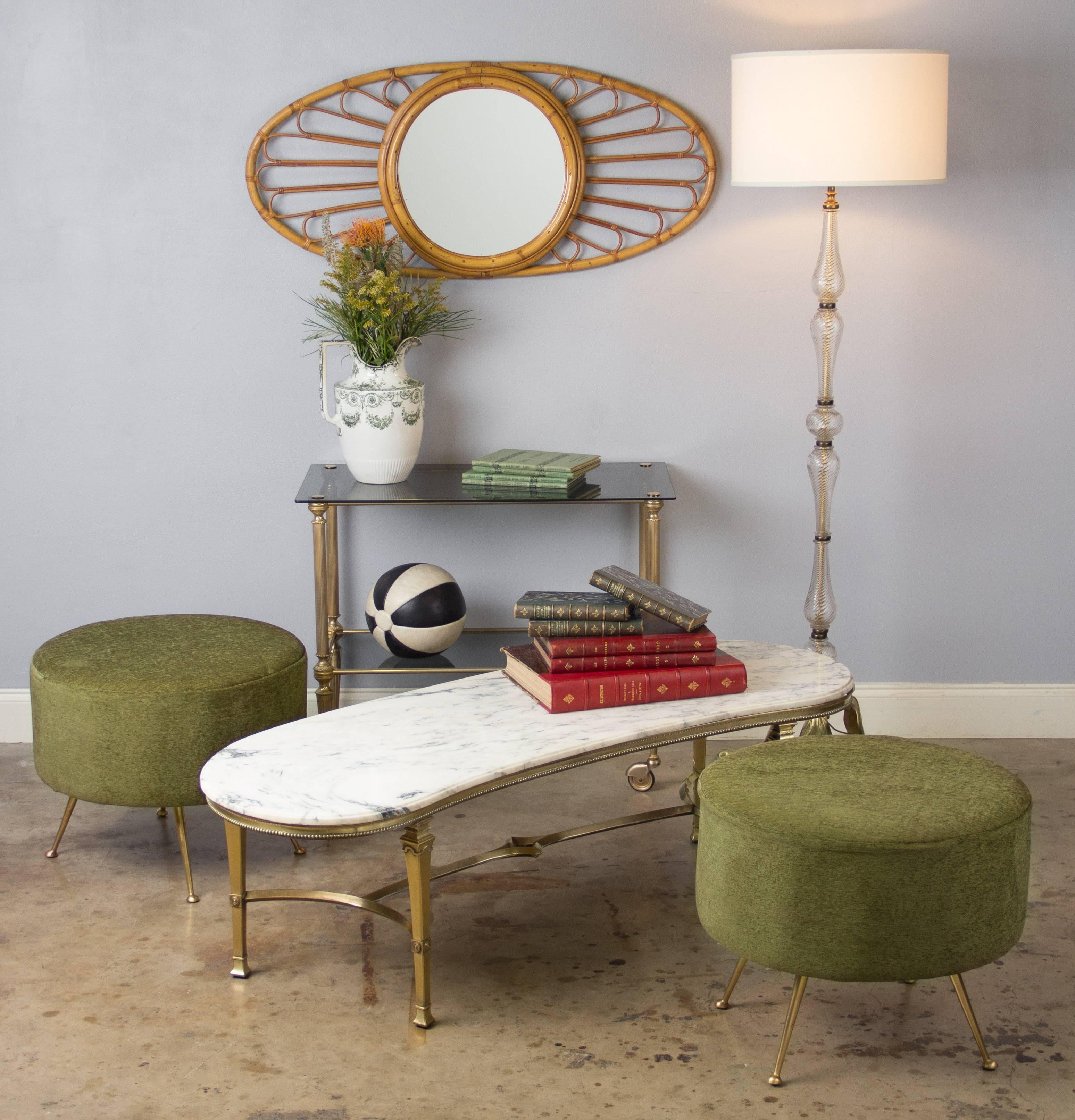 A great pair of round ottomans or poufs from Italy, circa 1960s, with an olive green mohair seat and slanted brass legs. Large and very comfortable, wonderful Mid-Century design.