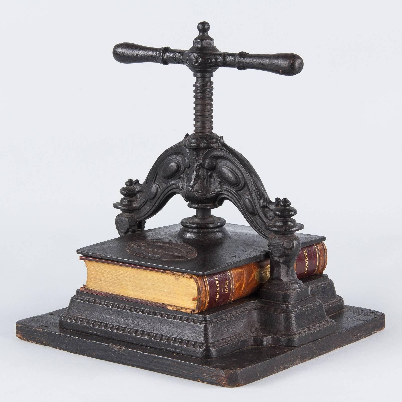 A beautiful book press from the Napoleon III Period made by the Papeterie Generale in Lyon France. The black cast iron press is in working order. The base is pinewood painted black.