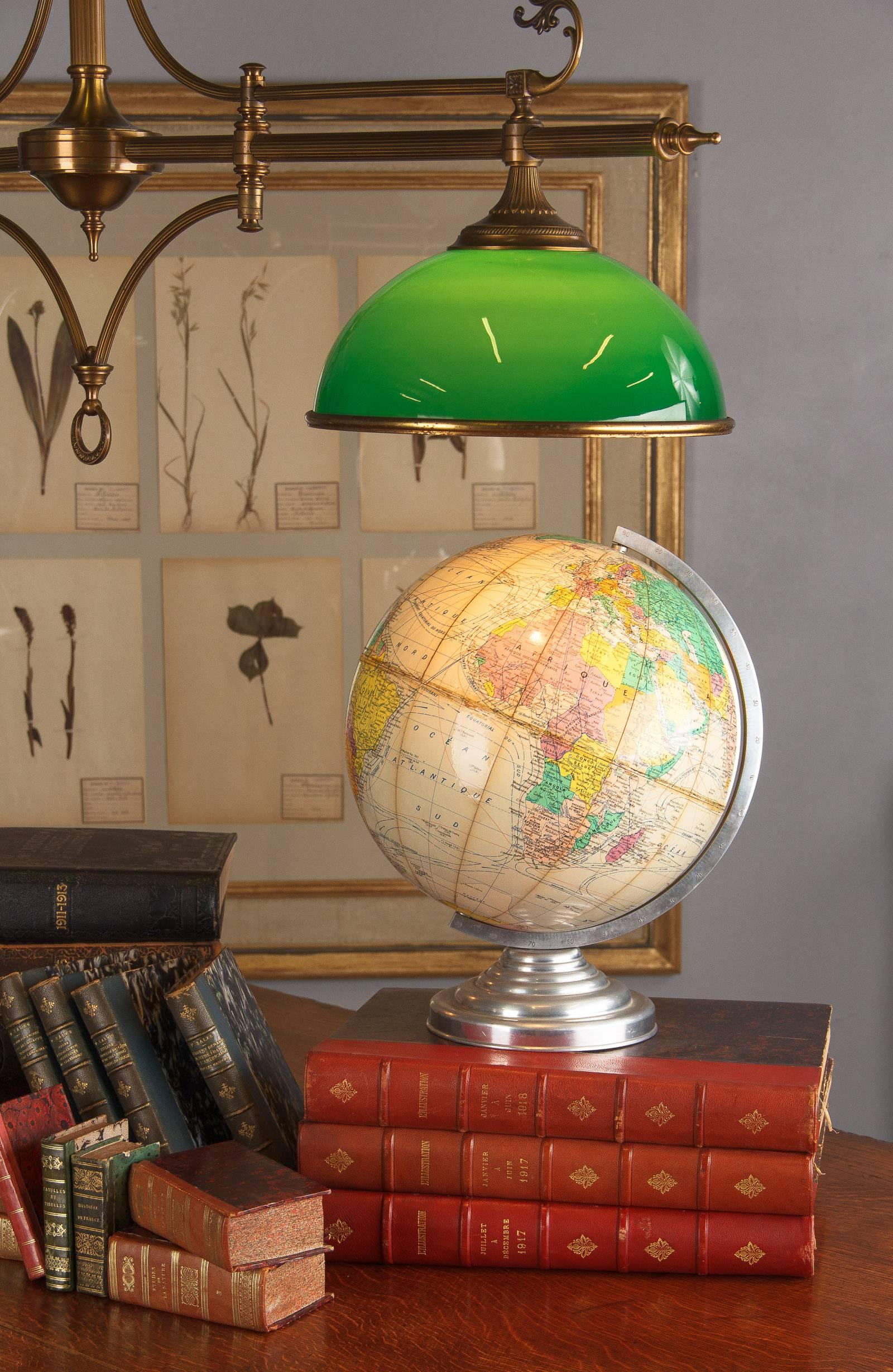 A 1960s terrestrial globe made in France with a papier mâché sphere rotating on an aluminium support.