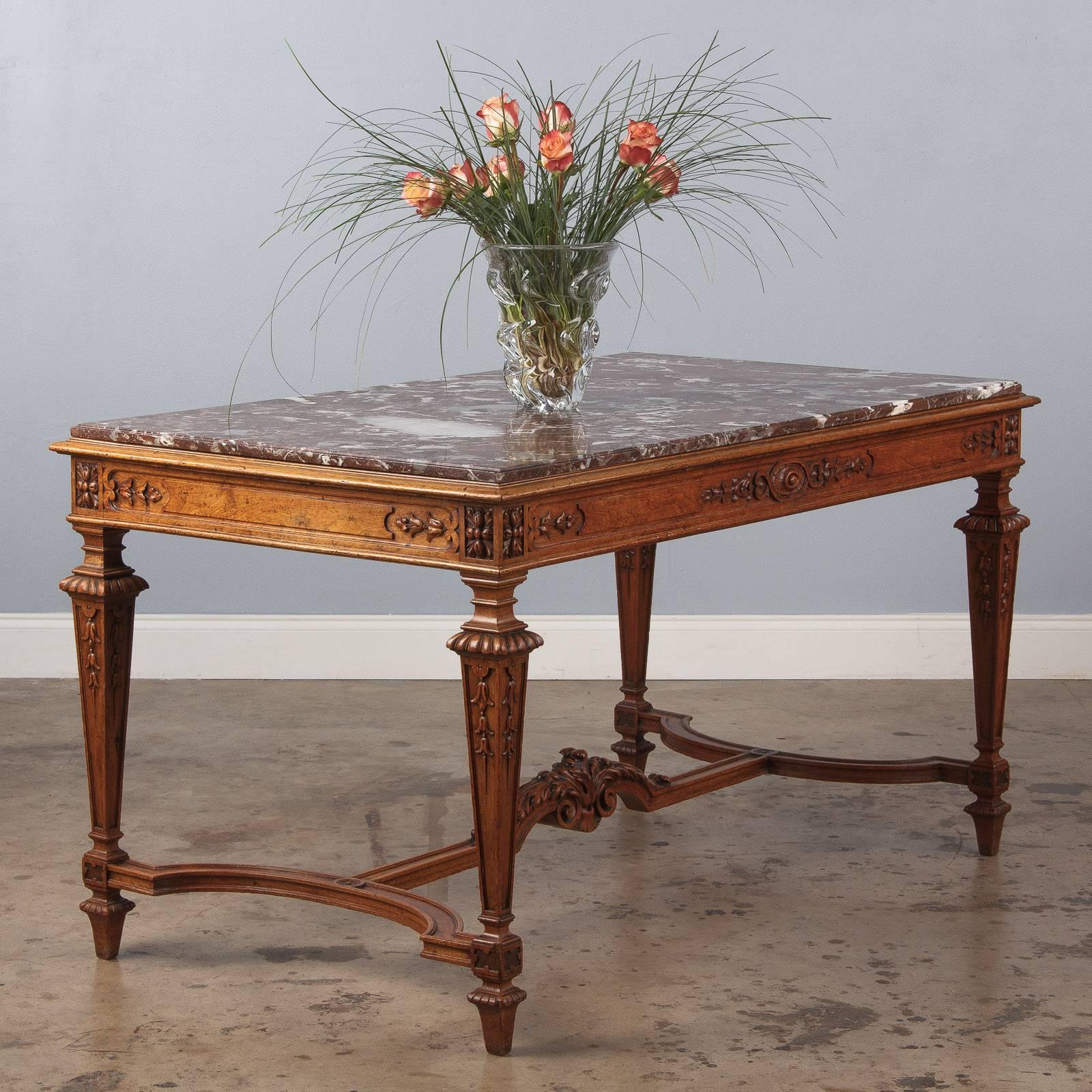 An elegant, stately center table made of golden oak with a red Languedoc marble top in the Louis XIV style, circa 1860s. These tables were called "Tables a Gibier" (wild fowl and game) and were used by hunters to drop their prey. A very