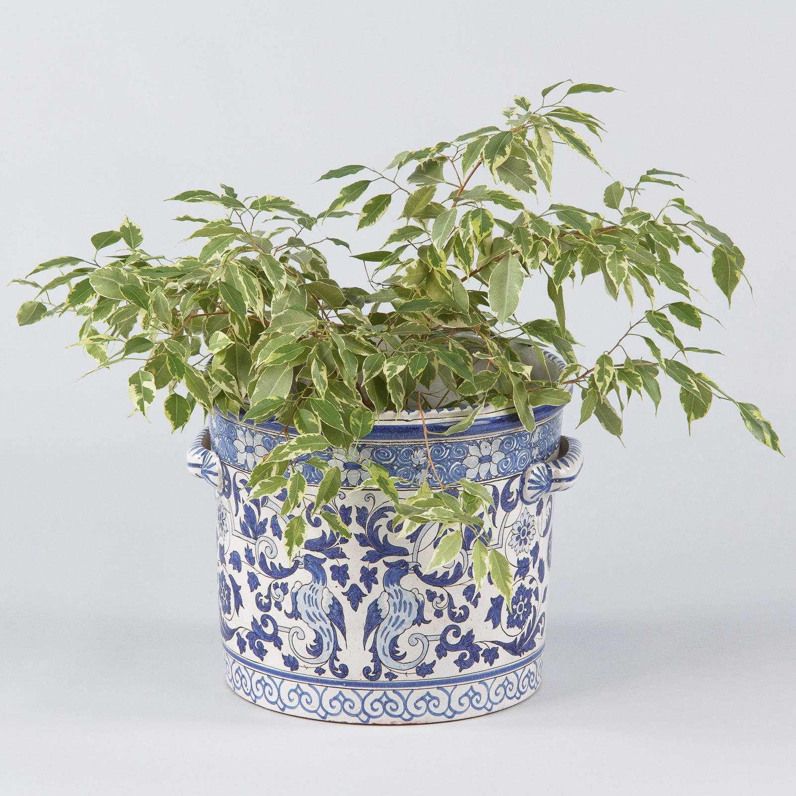 A blue and white glazed Nevers ceramic jardiniere with two handles. A 19th century piece with hand-painted designs of birds and arabesques. Perfect for a plant holder or kitchen and bath storage, it measures 13" high by 16.5" wide.

Good