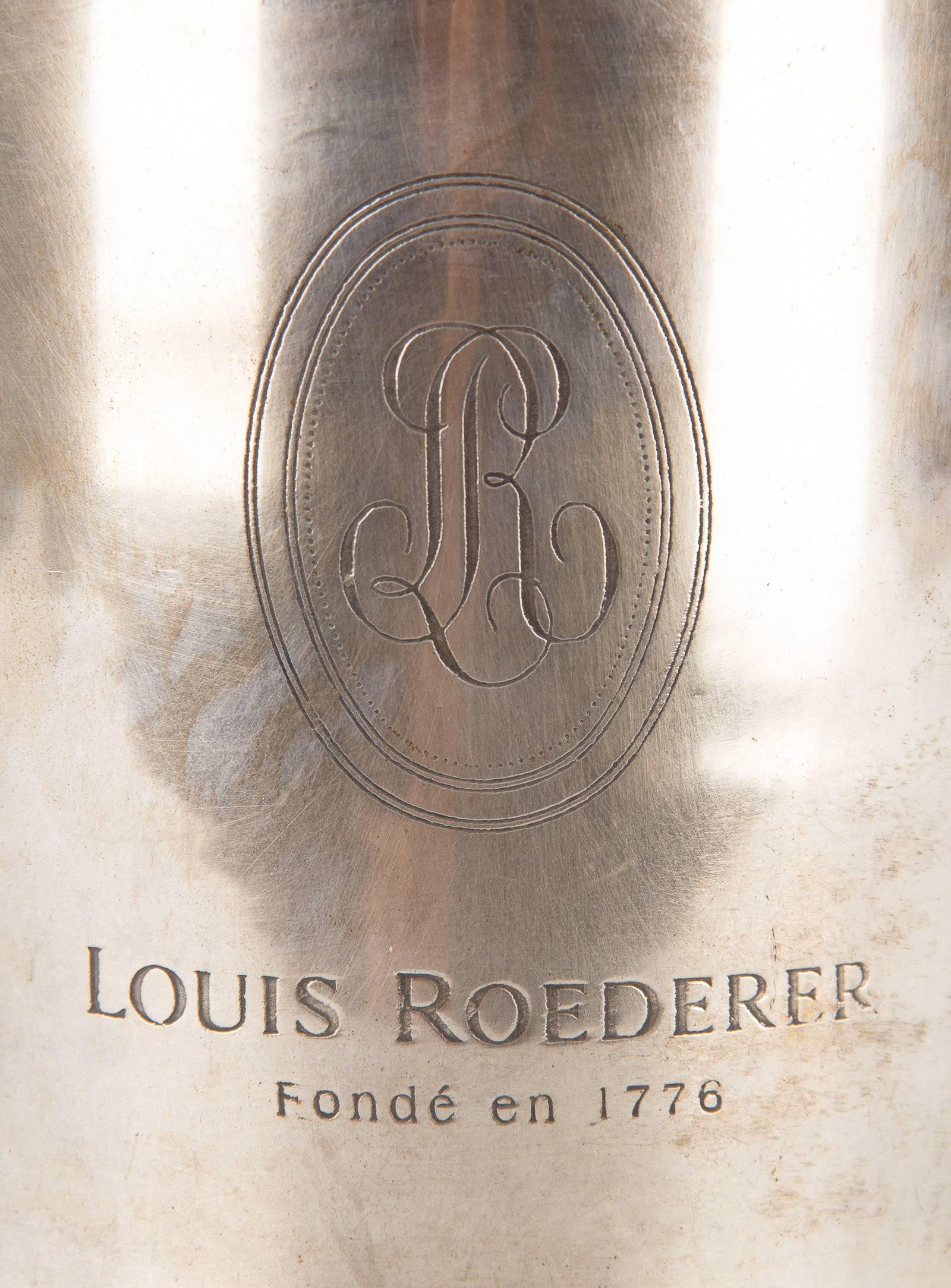 A silver plated Roederer Champagne Ice Bucket with embossed label, scalloped top, reeded circular base and shaped handles.