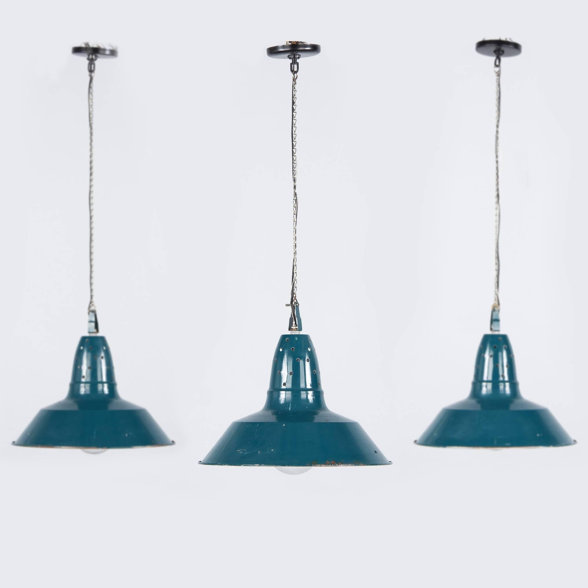 A set of three 1950s French Industrial Suspension Lights in blue/green metal. The chain and canopy add an additional 24