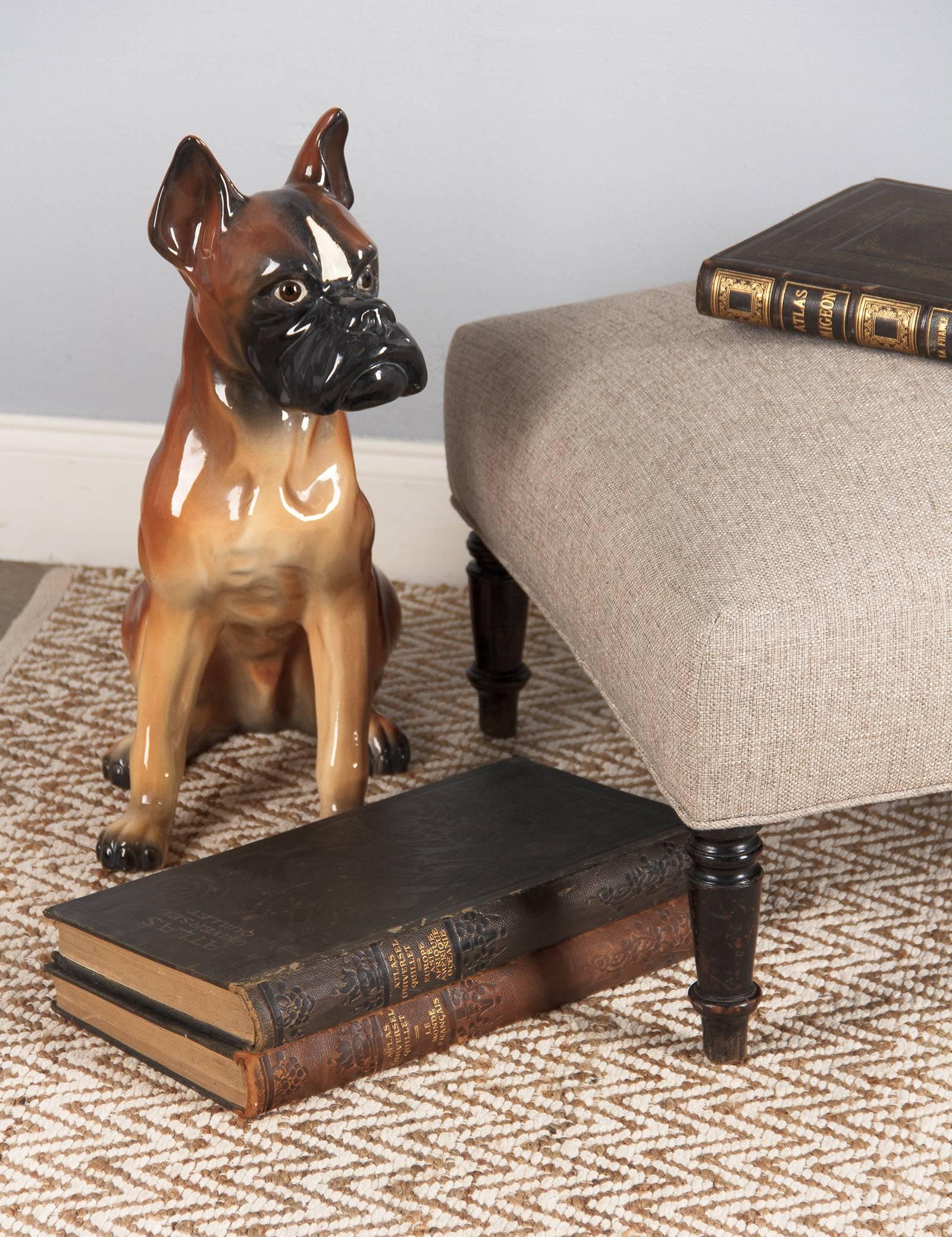 A large and comfortable square Napoleon III period ottoman with turned legs in ebonized pear wood. Newly re-upholstered in a light grey textured fabric. The perfect footrest or step up to the bed for your favourite dog!