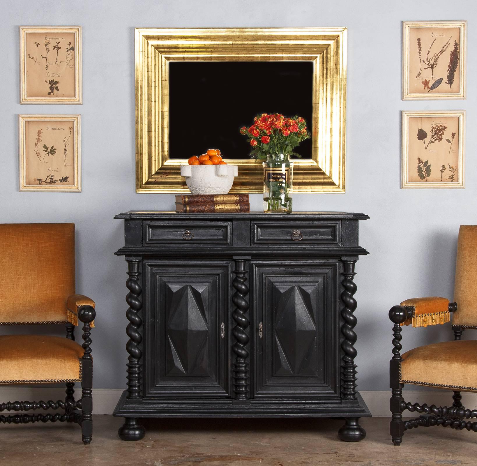 A statuesque French buffet in the Louis XIII style dating from the 18th century. The buffet was once ebonized on walnut but was recently repainted in black with a light grey interior. The buffet rests on bun feet and features two drawers and two