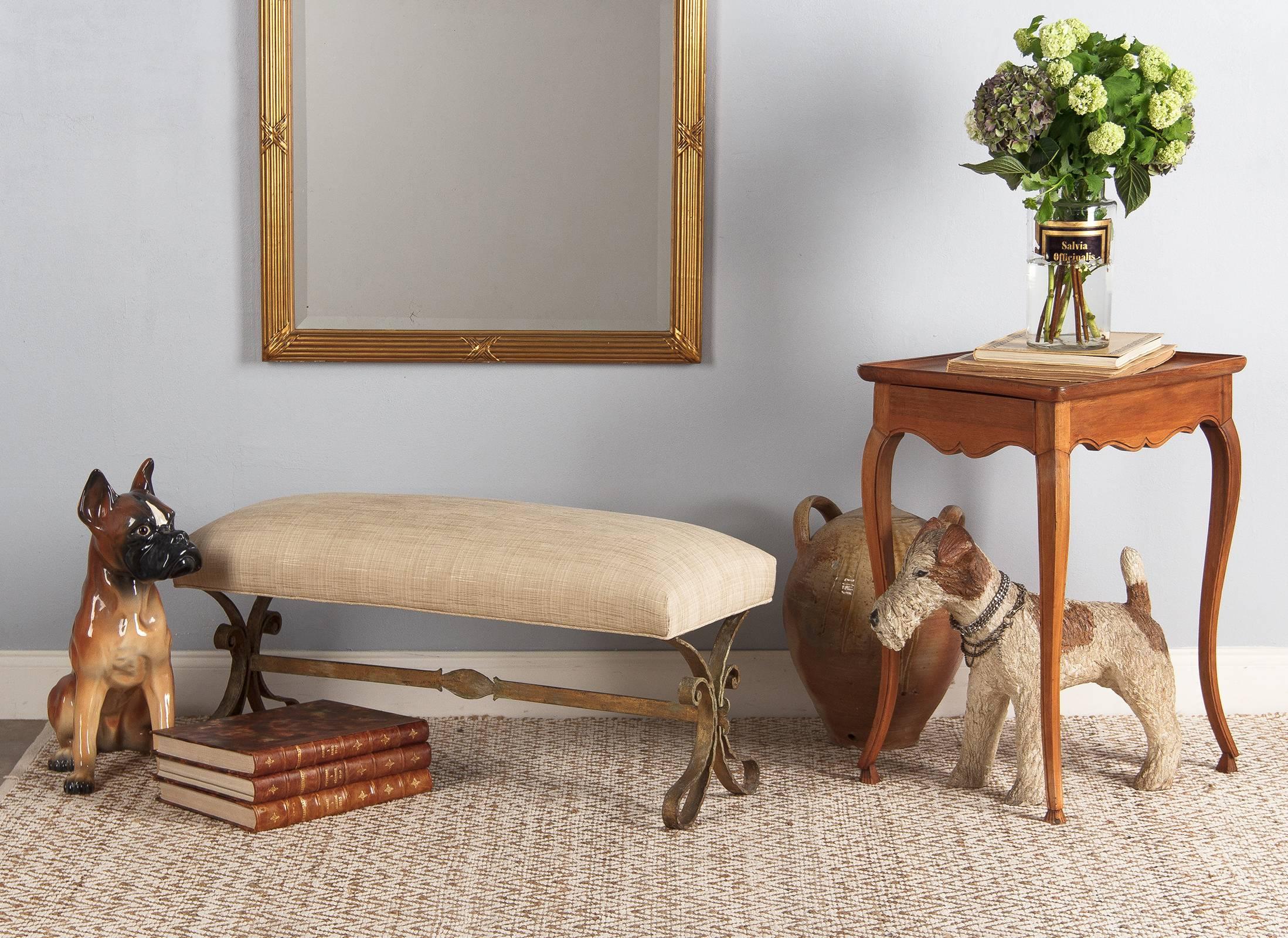 A gilt Iron bench with an antique finish from Barcelona, Spain, circa 1950s. The base has scrolled designs and a stretcher. The upholstery is new.