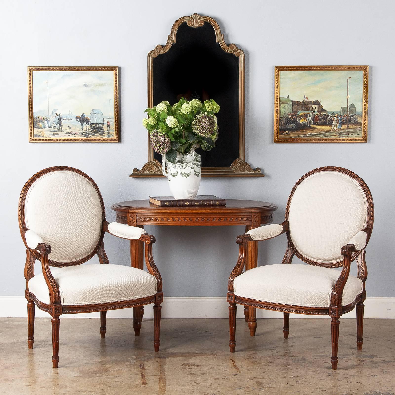 A Louis XV style mirror made of carved beechwood  painted in bronze and grayish tones. The piece was originally used as the top of a vanity table, so it has a flat bottom. A pair of carved acanthus scrolls anchor the base, then the frame stretches