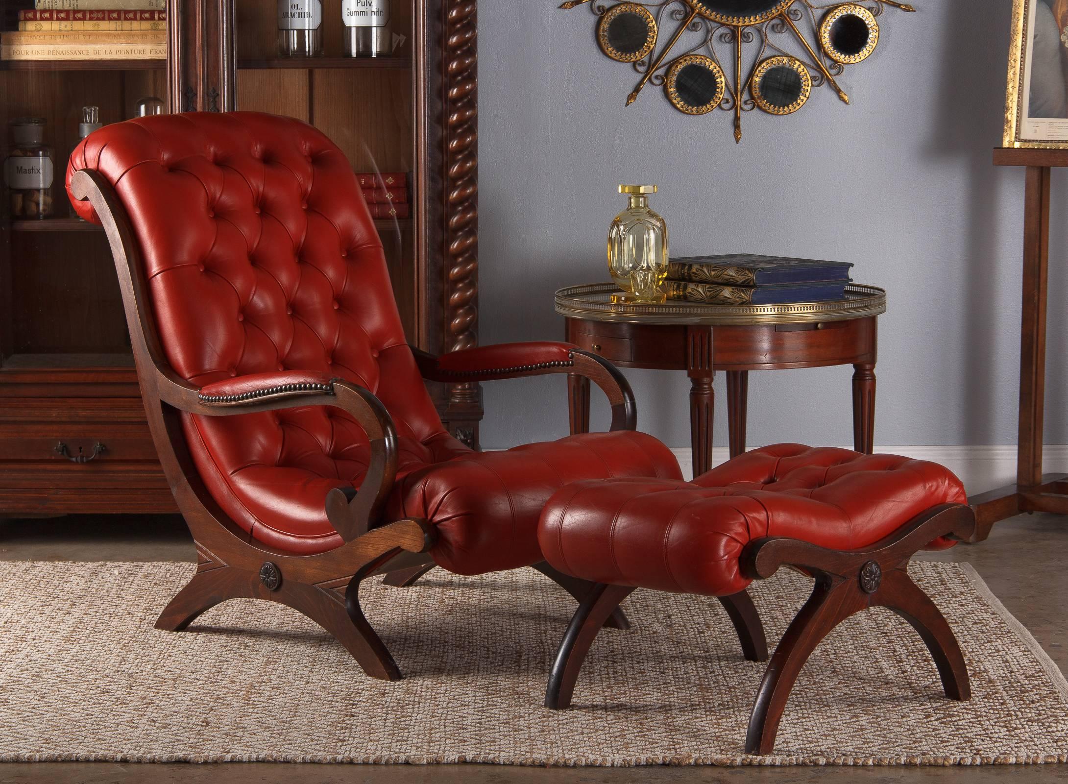 A fantastic two-piece Curule lounge seating Chesterfield set in fire-engine red tufted leather. The deep toned beech wood frames have the Classic Curule, or X shaped, structure and feature raised rosettes, carved chevron detailing and scrolled