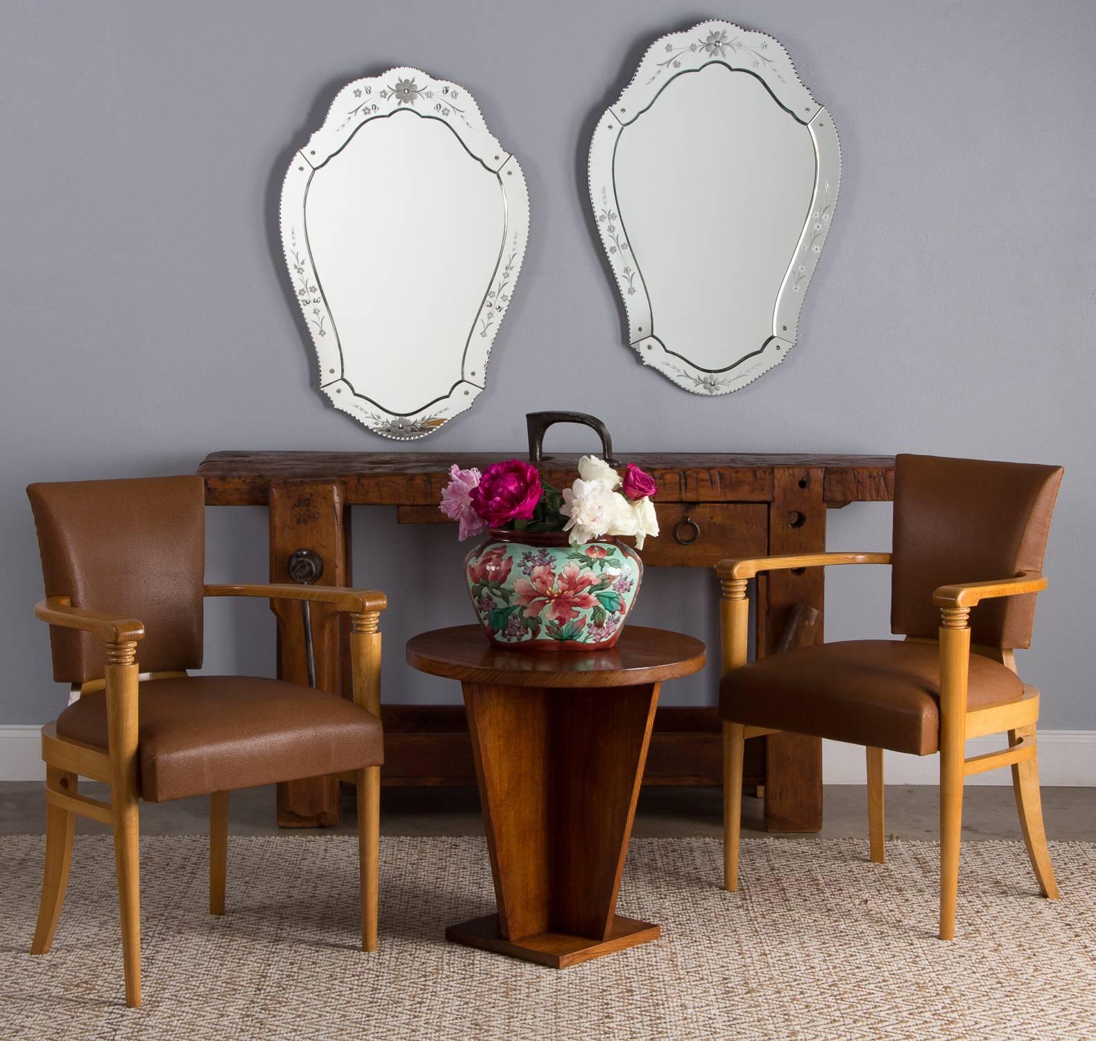 A pair of fancy vintage French Art Deco bridge chairs, circa 1930. High Art Deco shines through on the light-toned birch wood frames. The arms rest on tapered legs capped with a carved set of three graduated concentric rings. The back legs are