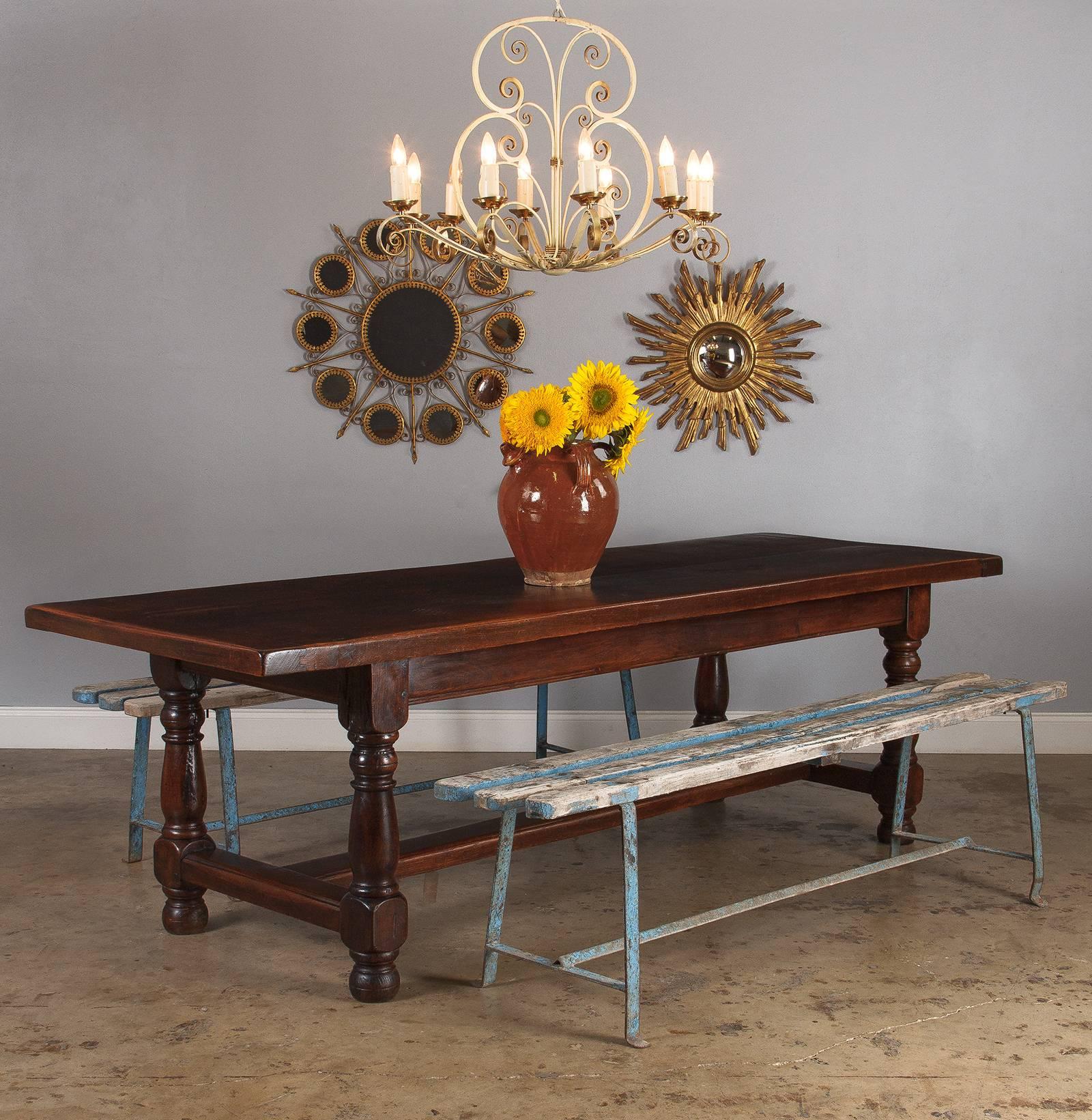 A marvelous French oak farm table with heavy baluster legs, circa 1870s. The top consists of two great oak slabs joined at the center and capped on either end with a matching piece of oak. In typical French fashion, the table is long and narrow.