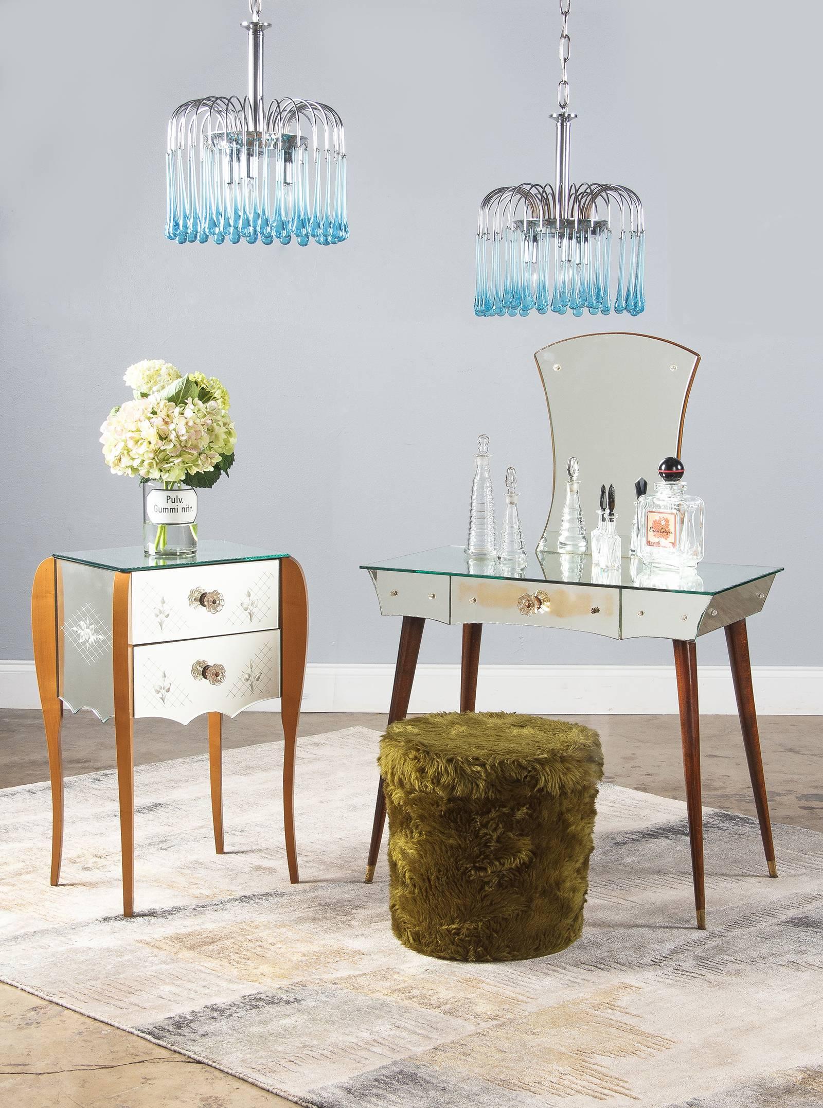 A beguiling Mid-Century Venetian mirrored glass nightstand and chest of drawers, circa 1950. Four gracefully curving birch wood legs rise up from slender feet and broaden as they go up. The widest part of each leg is attached to a corner of the