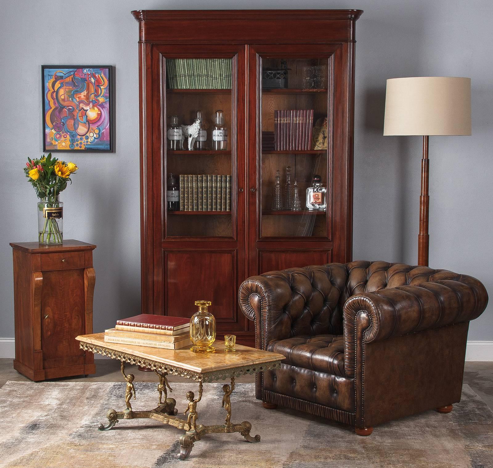 A stately restoration period cabinet or nightstand in walnut, early 1800s. With a slim profile and geometric simplicity of form, this little piece will fit in beautifully with a variety of styles. A plinth base glides on four metal casters. Flat