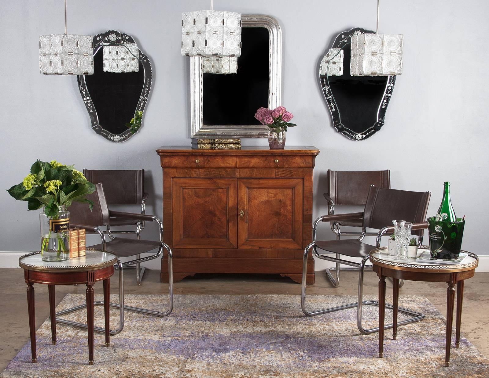 A pleasant bouillotte side table in the Louis XVI style with Carrara marble top, circa 1940s. Beechwood construction in warm-toned medium brown with a round top and four turned, tapered and fluted legs. A pierced brass gallery with geometric design