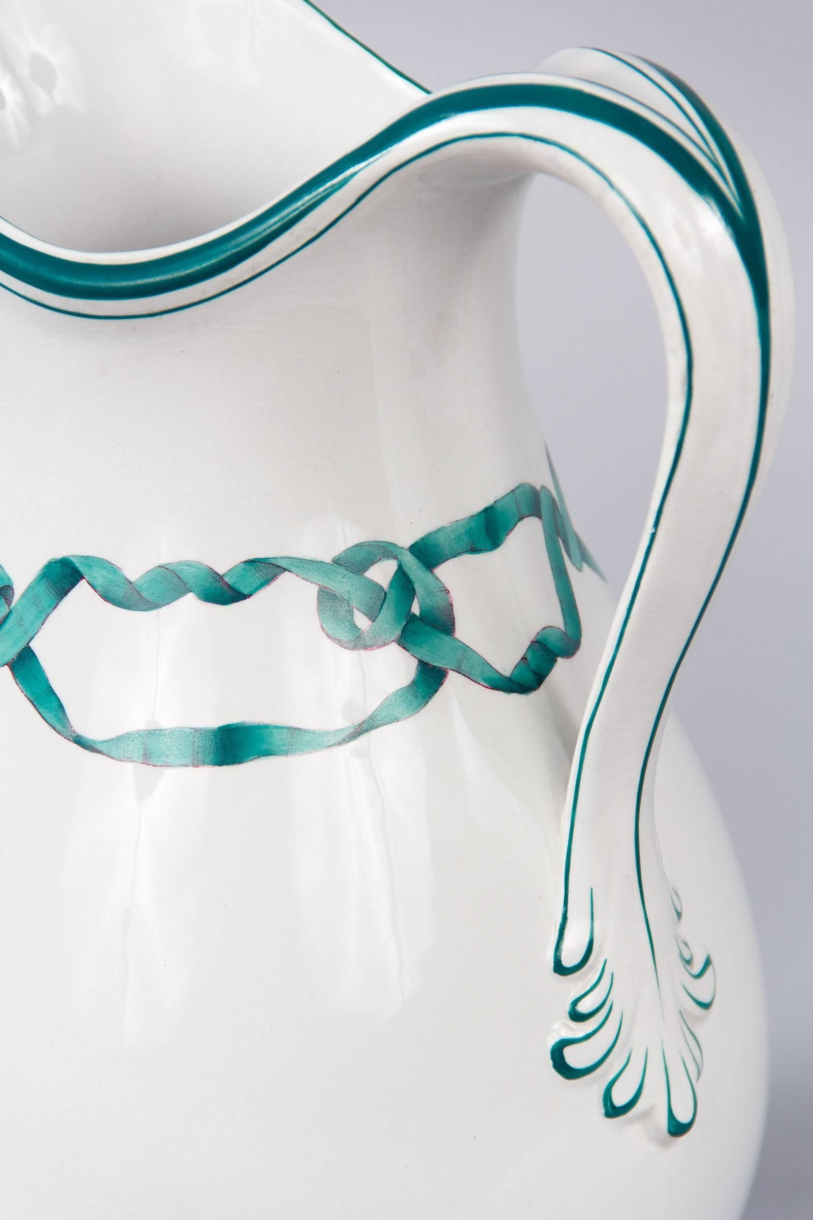 French vintage white ceramic pitcher with hand painted details, circa 1950. Classic, graceful form with a curved lip that carries over to the fluidly shaped handle. The rim and handle are fully accentuated with hand painted deep green lines, echoed