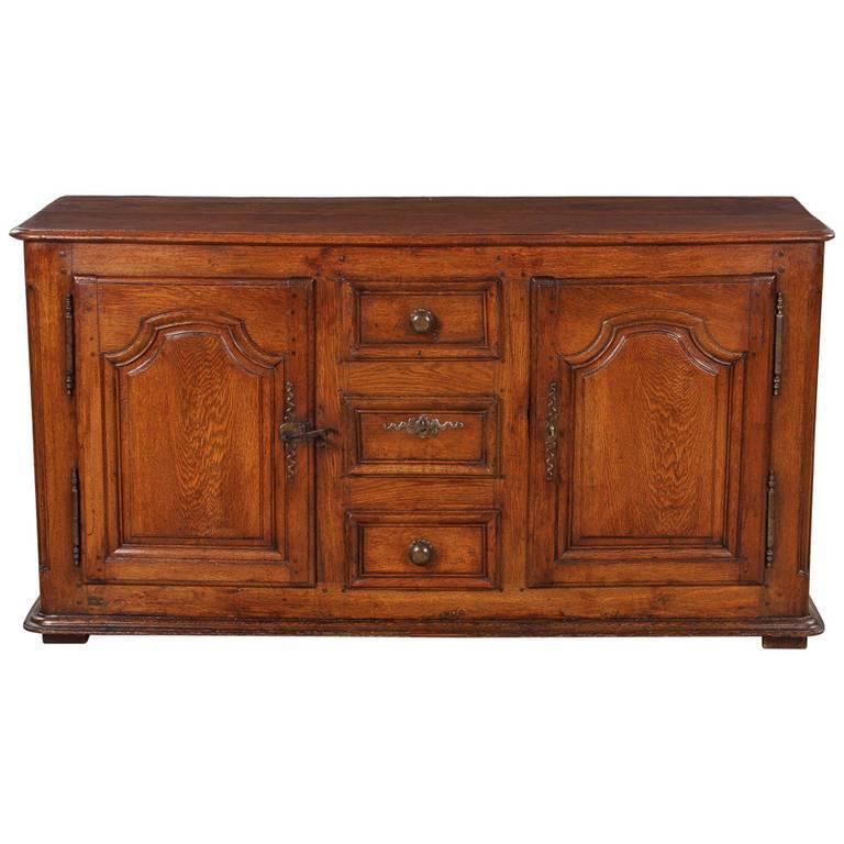 Gorgeous antique oak patina on this 18th century Louis XIV style buffet. The two-paneled doors are arched. The left door has its original hardware and a lock was installed on the right door. The inside has one shelf in each compartment (Inside