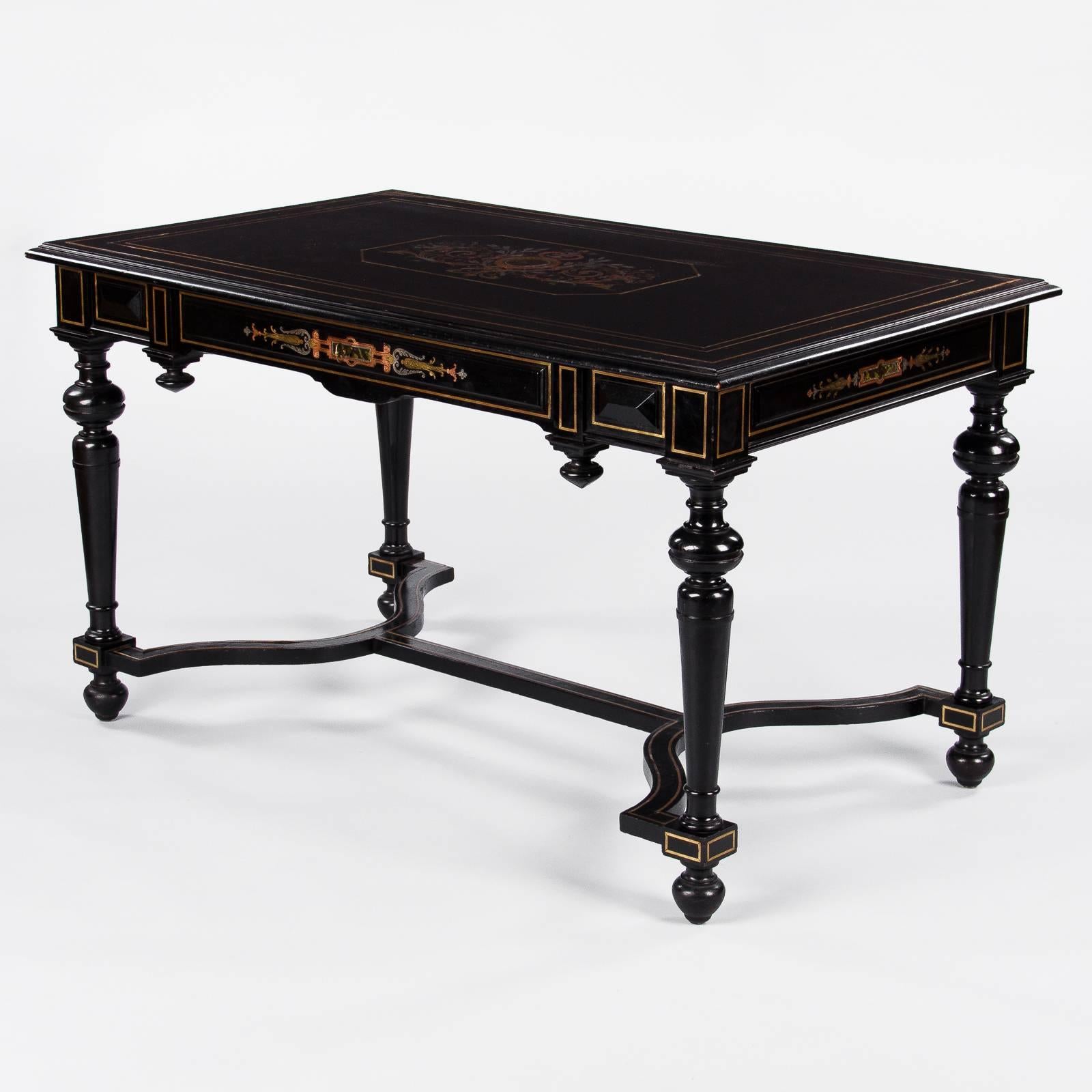 A stunning Napoleon III desk made of ebonized pear wood with brass inlay. Intricate arabesque inlay designs around the apron on the drawer and on top mixing brass, pewter and copper. More fine details with toupie finials under the apron, baluster