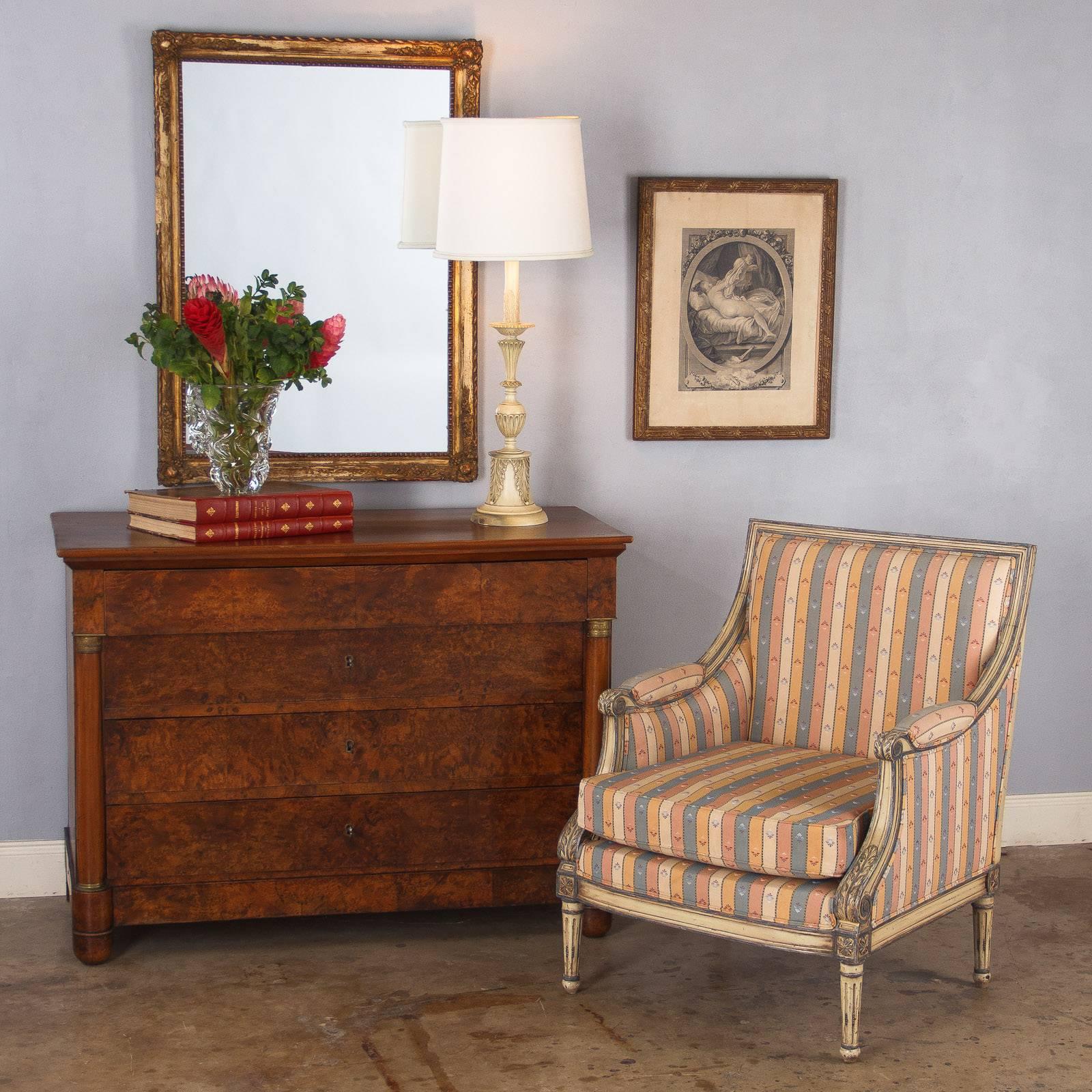 This classic French Empire period commode features a gorgeous burl walnut facade and elegant bronze ornaments on the columns framing the chest. With four drawers, the top and sides are made of solid walnut. An absolutely stunning chest that will